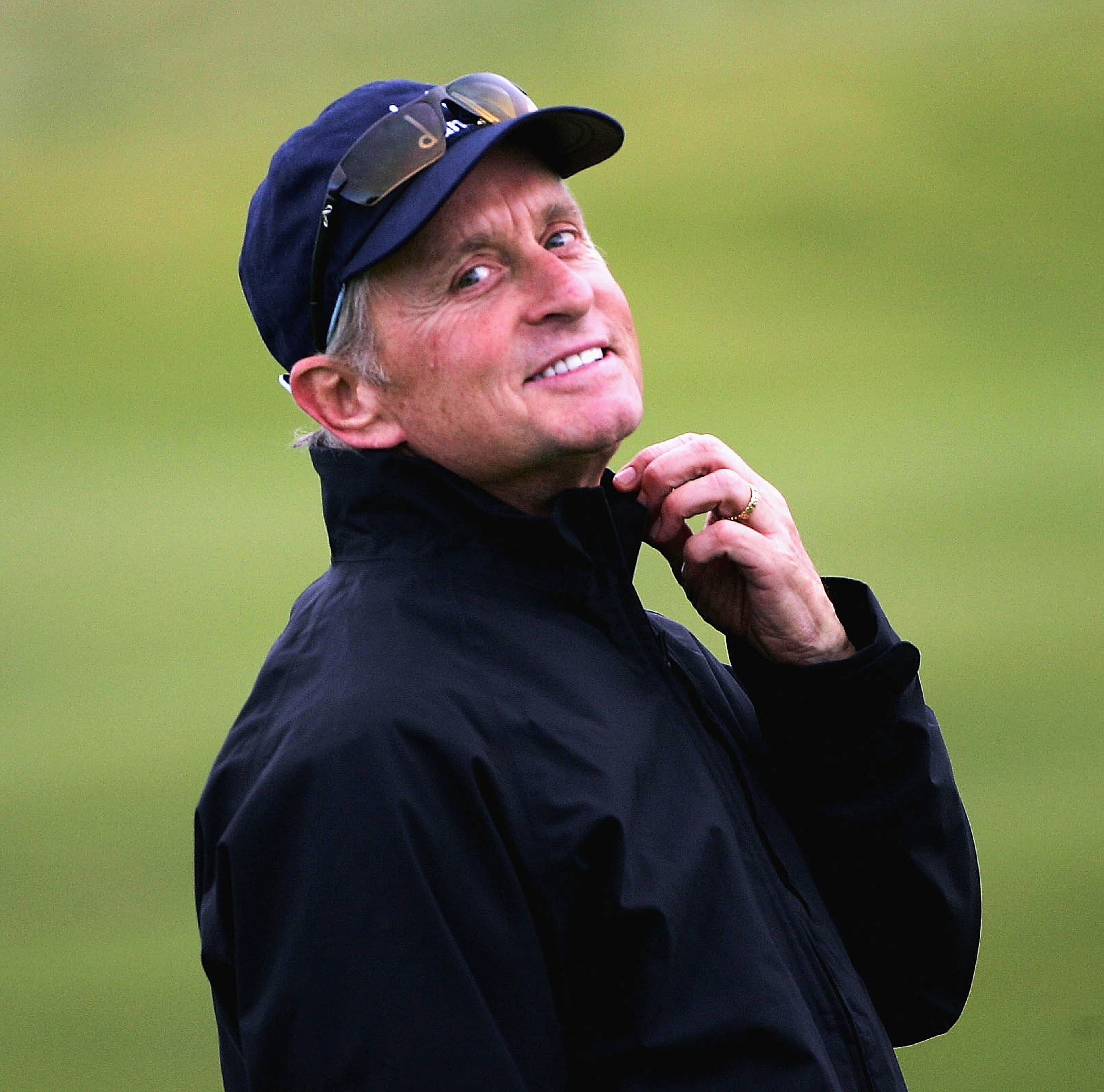 CARNOUSTIE, SCOTLAND - OCTOBER 9: Michael Douglas, the Hollywood actor, adjusts his collar on the fourth hole during the third round of of the Dunhill Links Championship at Carnoustie Golf Club on October 9, 2004 in Carnoustie, Scotland. (Photo by Andrew Redington/Getty Images)
