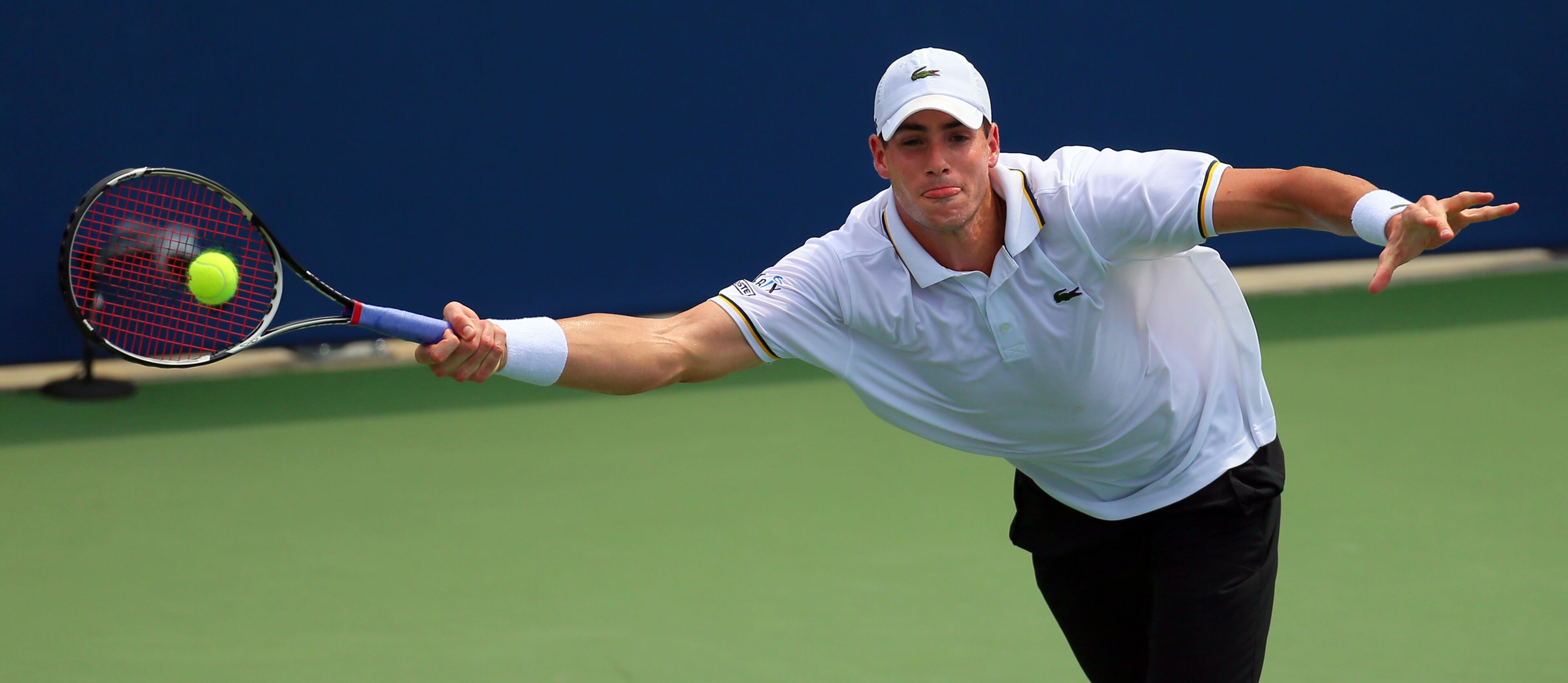 John Isner stretches to return a serve to Kevin Anderson on his way to winning the BB&T Atlanta Open 6-7 (3), 7-6 (2), 7-6 (2) on Sunday, July 28, 2013, in Atlanta.