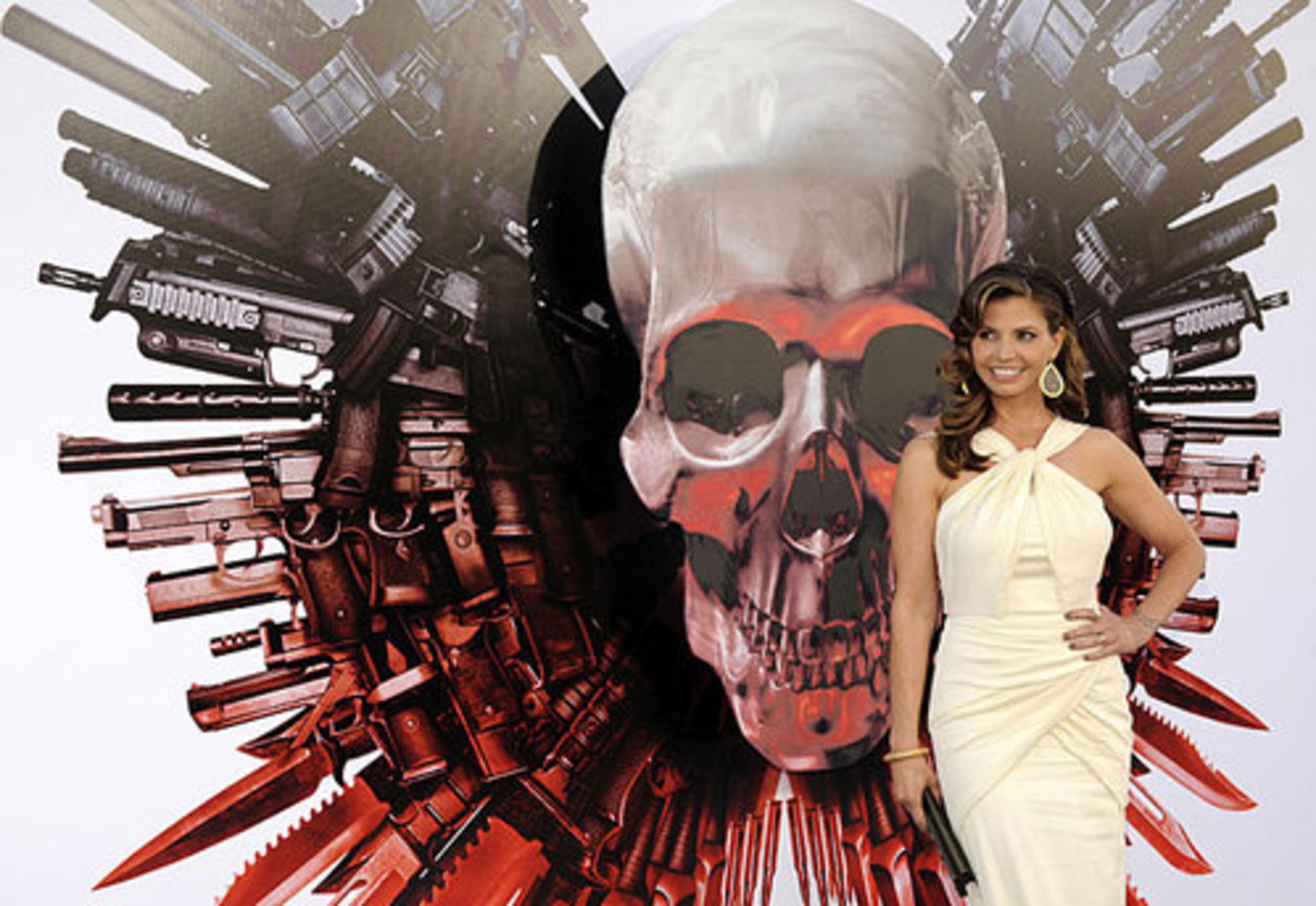 Charisma Carpenter, a cast member in "The Expendables, " poses at the premiere of the film in Los Angeles, Tuesday, Aug. 3, 2010.