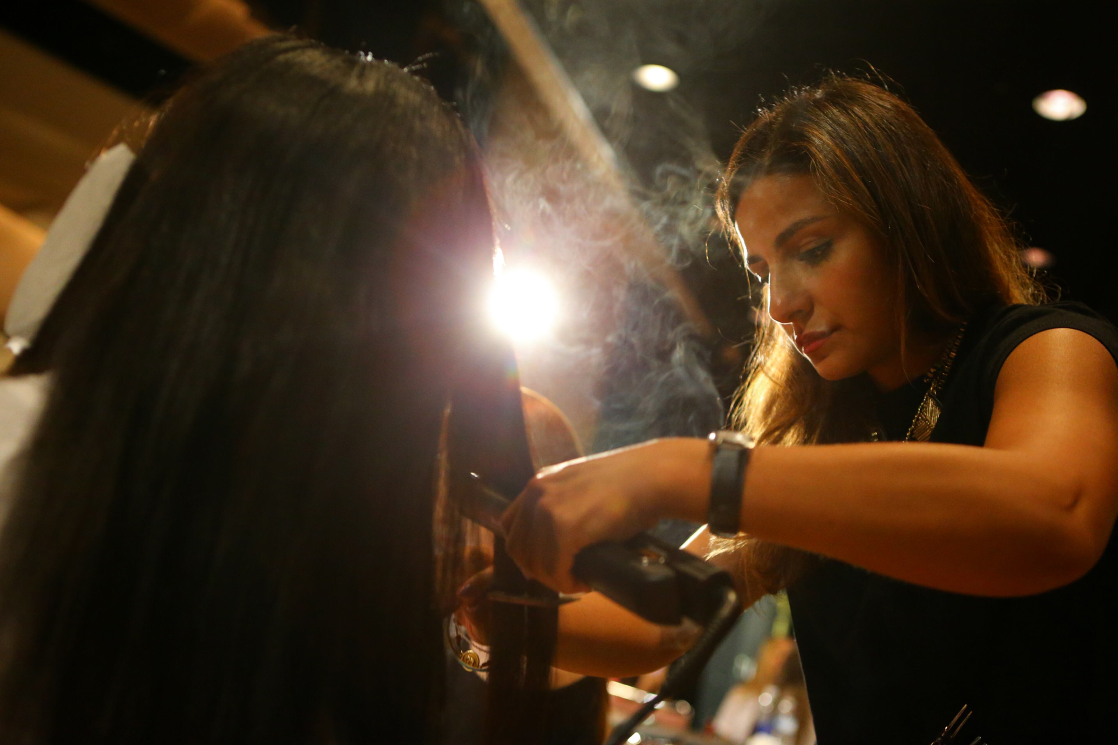 Stylist Dyana Nematalla prepares models' hair backstage for the Jeffrey Cares Fashion Show Monday, Aug. 25, 2014, in Atlanta. The show raises awareness and funds for its beneficiaries the Susan G. Komen for the Cure Greater Atlanta Affiliate and the Atlanta AIDS Fund. CURTIS COMPTON / CCOMPTON@AJC.COM