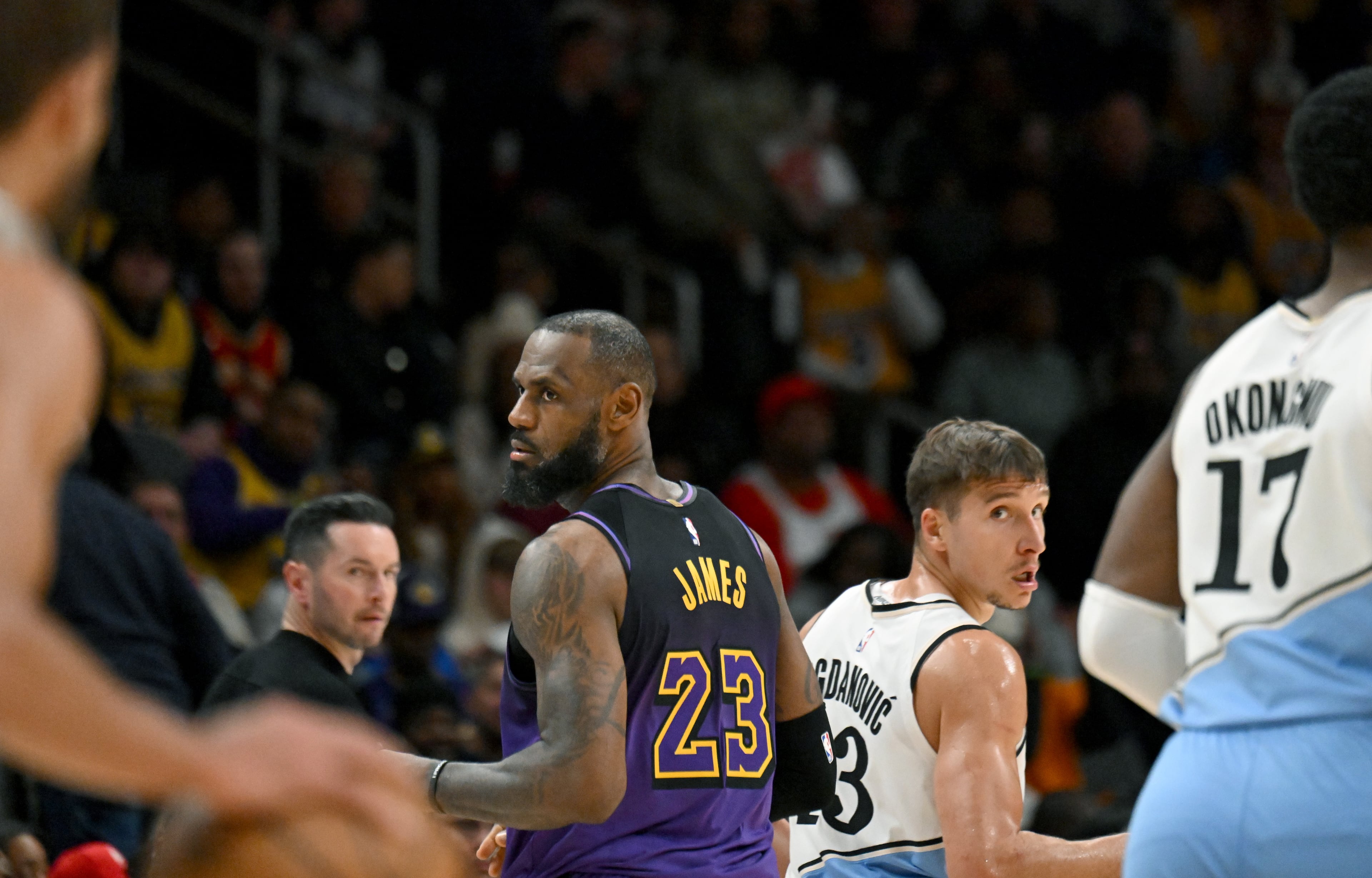 Los Angeles Lakers forward LeBron James (23) and Atlanta Hawks guard Bogdan Bogdanovic (13) run back upcourt during the second half in an NBA basketball game at State Farm Arena, Friday, December 7, 2024, in Atlanta. Atlanta Hawks won 134 - 132 over Los Angeles Lakers. (Hyosub Shin / AJC)