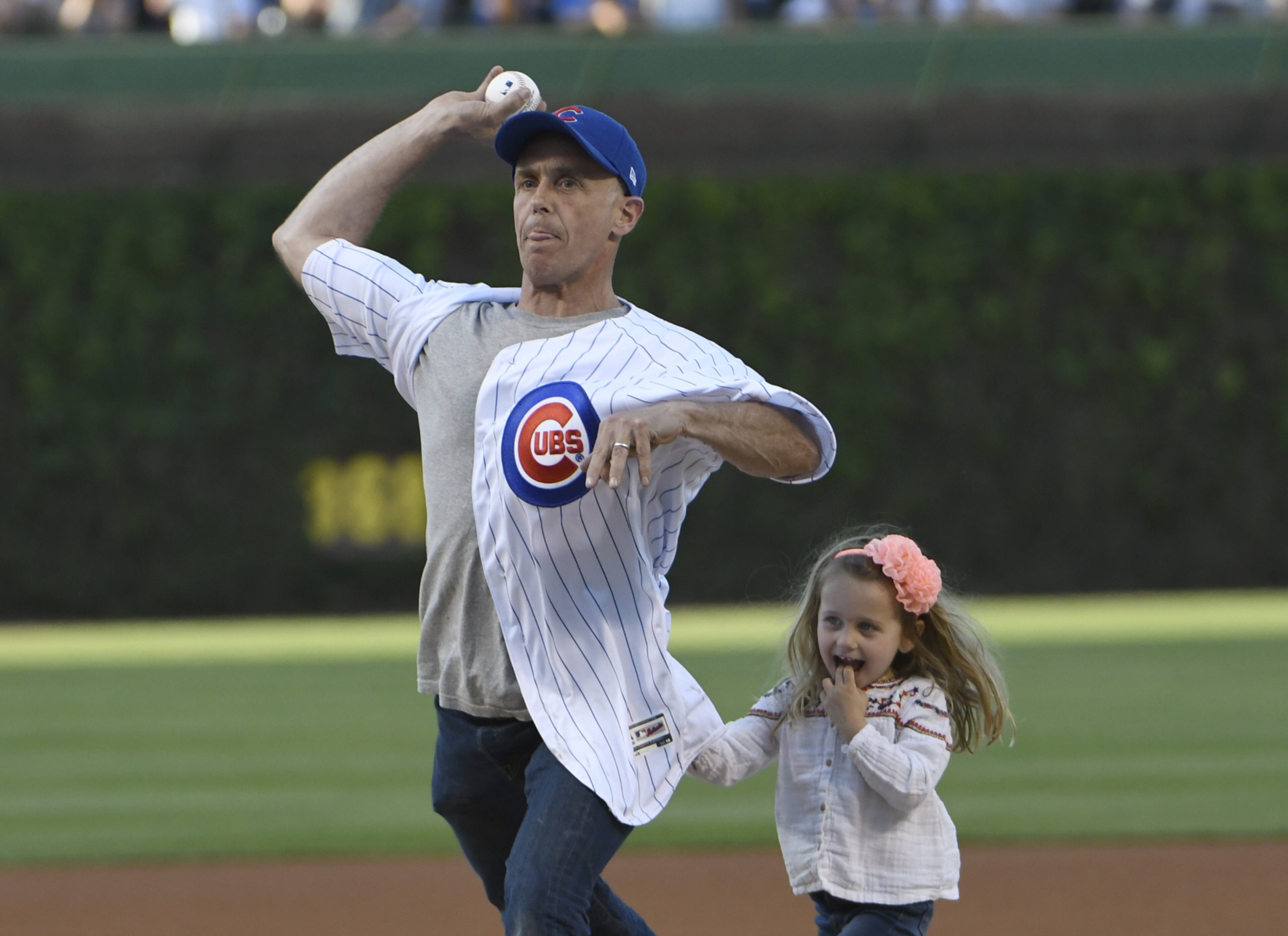 CHICAGO, IL - MAY 16: Television actor and star of Chicago Fire David Eigenberg throws out a ceremonial first pitch as his daughter Myrna watches before the game between the Chicago Cubs and the Cincinnati Reds on May 16, 2017 at Wrigley Field in Chicago, Illinois. (Photo by David Banks/Getty Images)