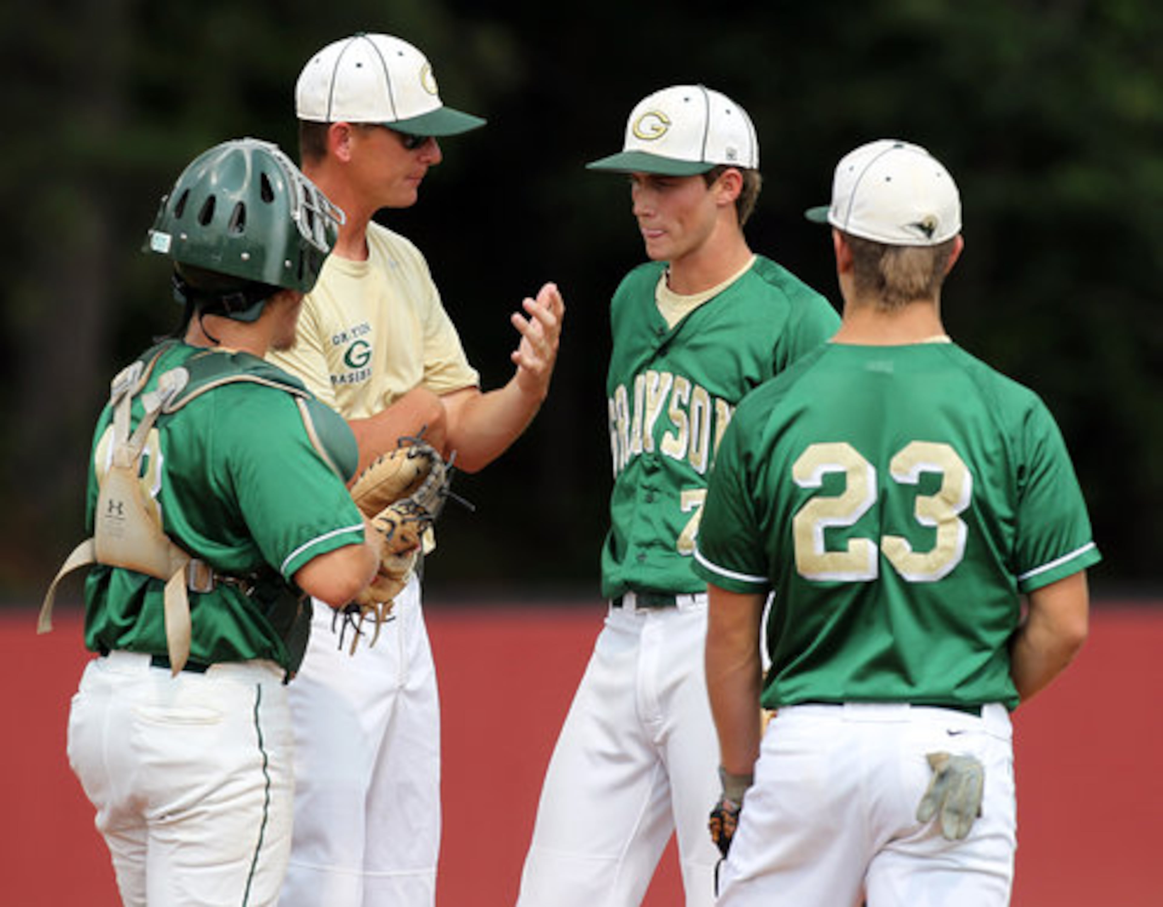Grayson head coach Seth Rhine confers with pitcher (7) Chris Erwin after falling behind 5-0 to Brookwood during the first inning in game one of a double header at Brookwood High School in Snellville on Monday, May 21, 2012. Brookwood took the first game 10-0 in five innings.