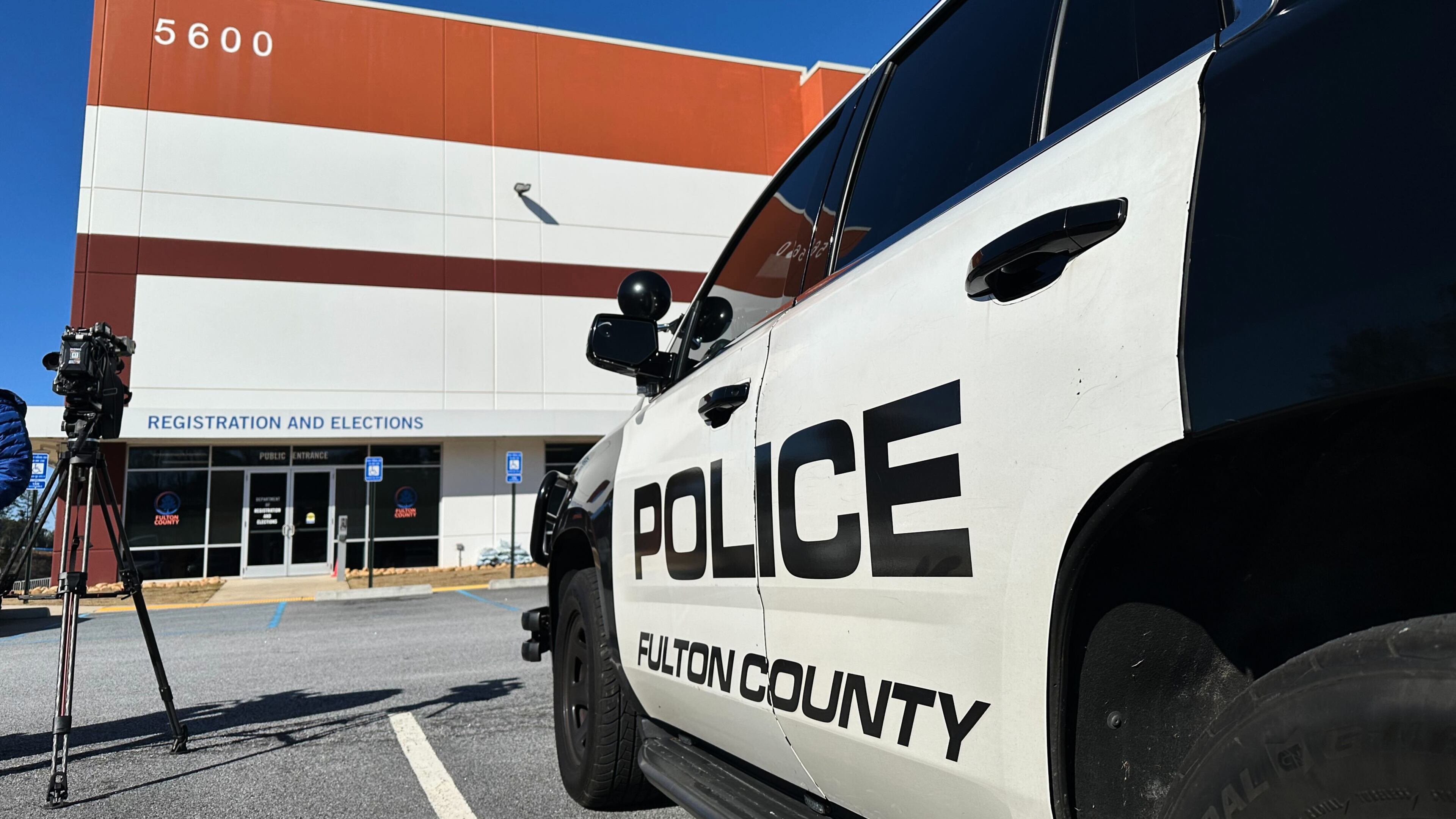 Police vehicles are seen outside the Fulton County elections hub in Union City, Ga., Wednesday, Jan. 28, 2026. (AP Photo/Emilie Megnien)