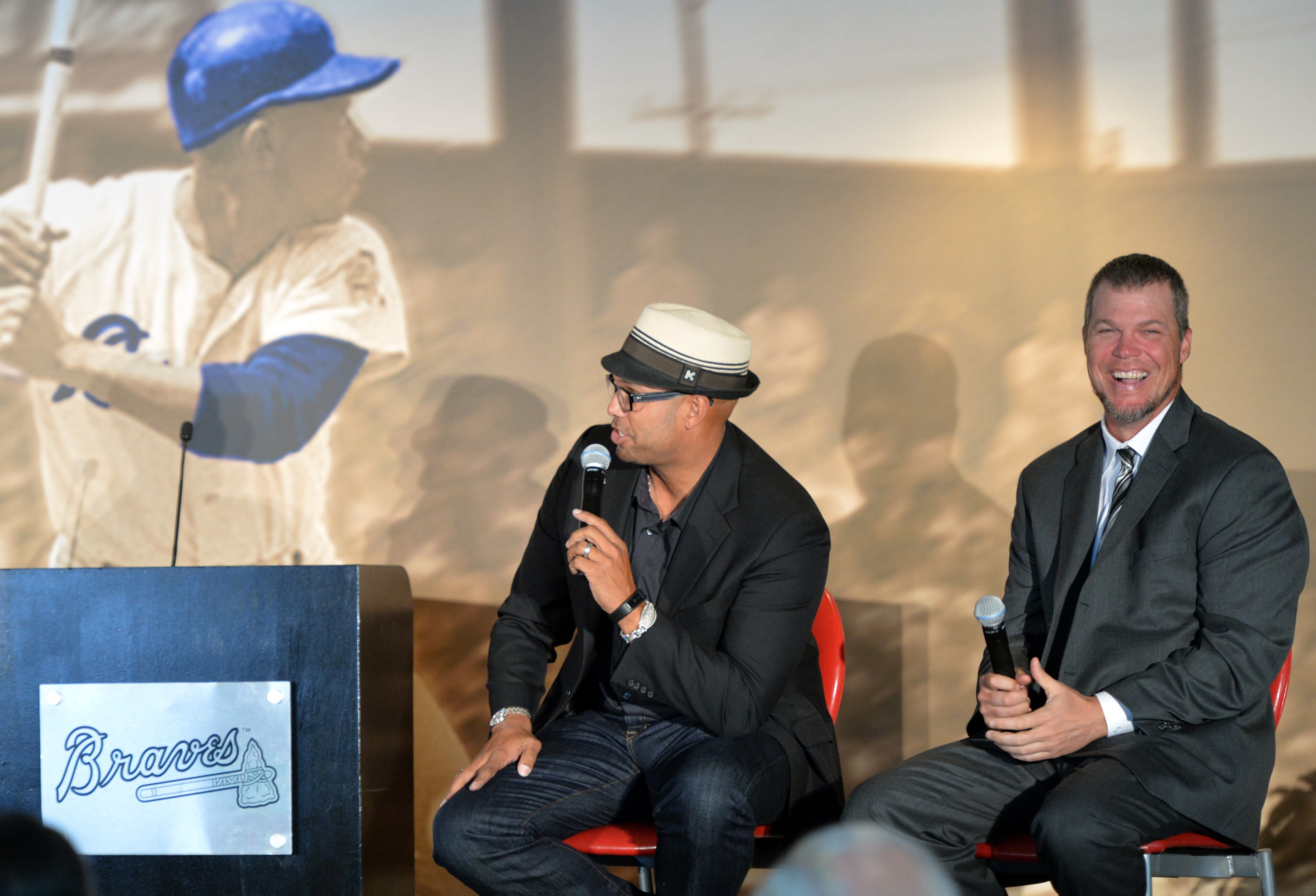 Chipper Jones (right) laughs at David Justice's words.