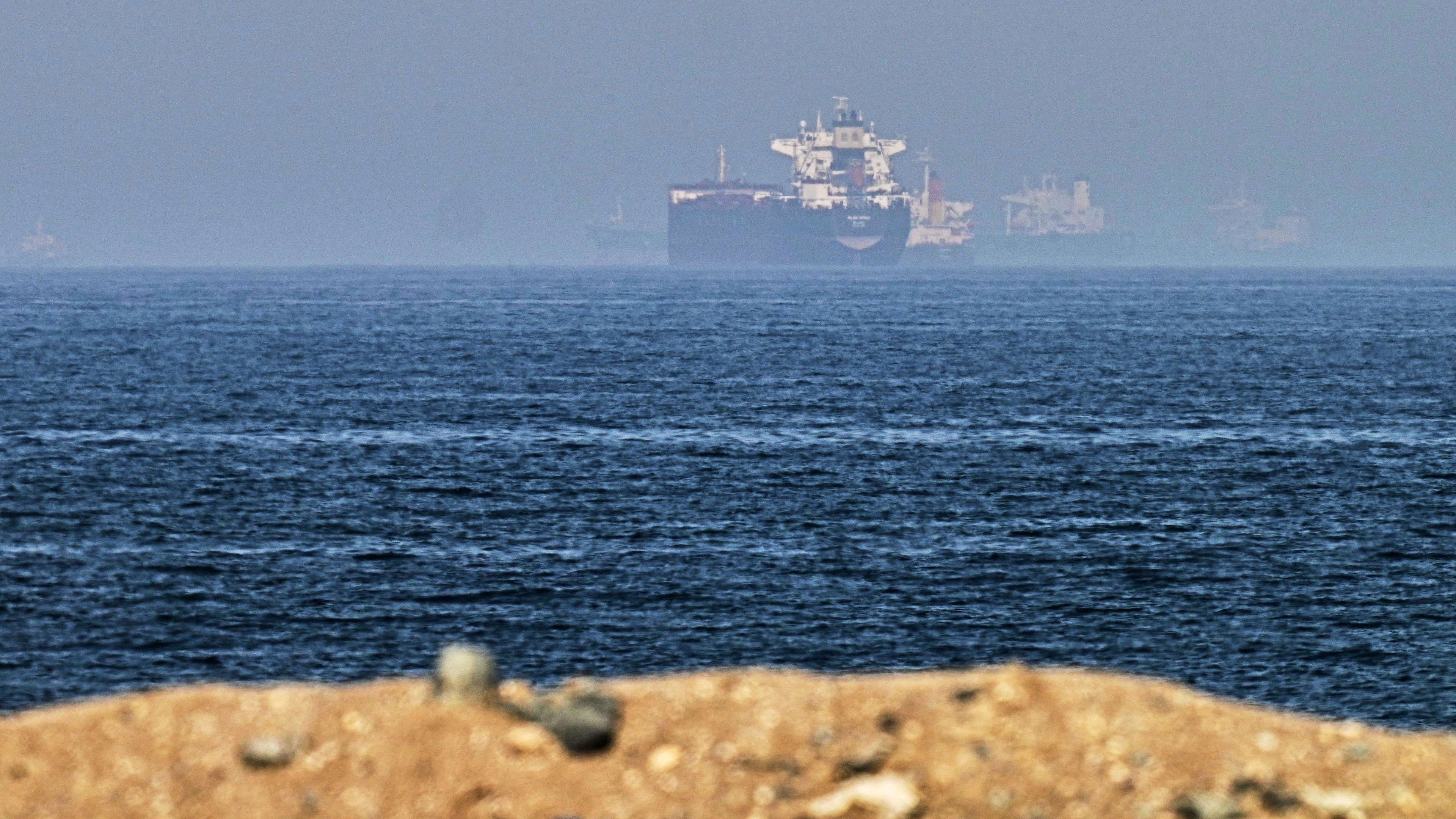 FILE - Cargo ships are seen at sea near the Strait of Hormuz, as viewed from a rocky shoreline near Khor Fakkan, United Arab Emirates, Friday, May 1, 2026. (AP Photo/Fatima Shbair, File)