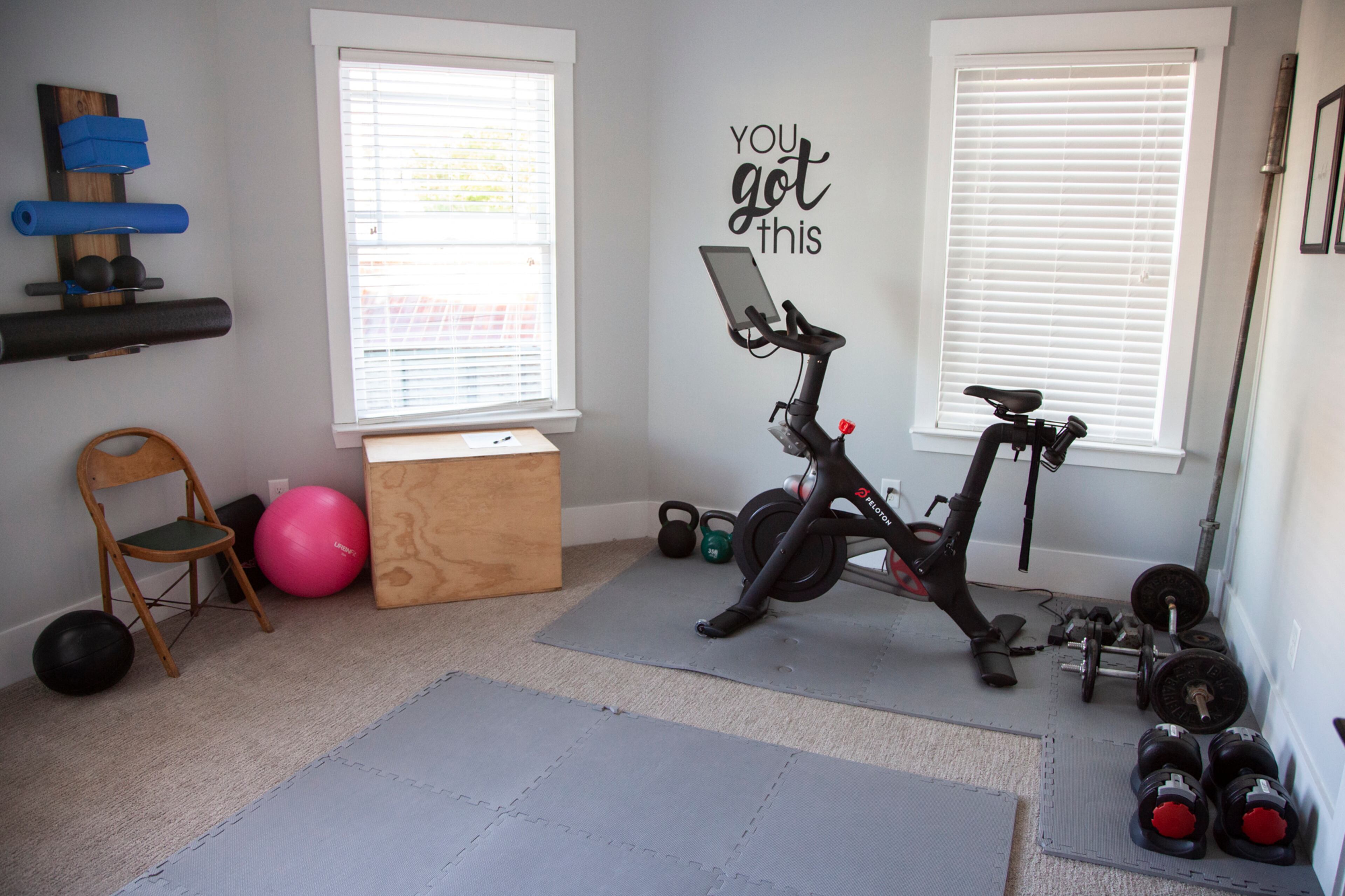 With five bedrooms in this Kirkwood home, Brad and Brigette Doss converted one into a workout space. The exercise room facilitates their active lifestyle, housing their Peloton and other workout equipment.