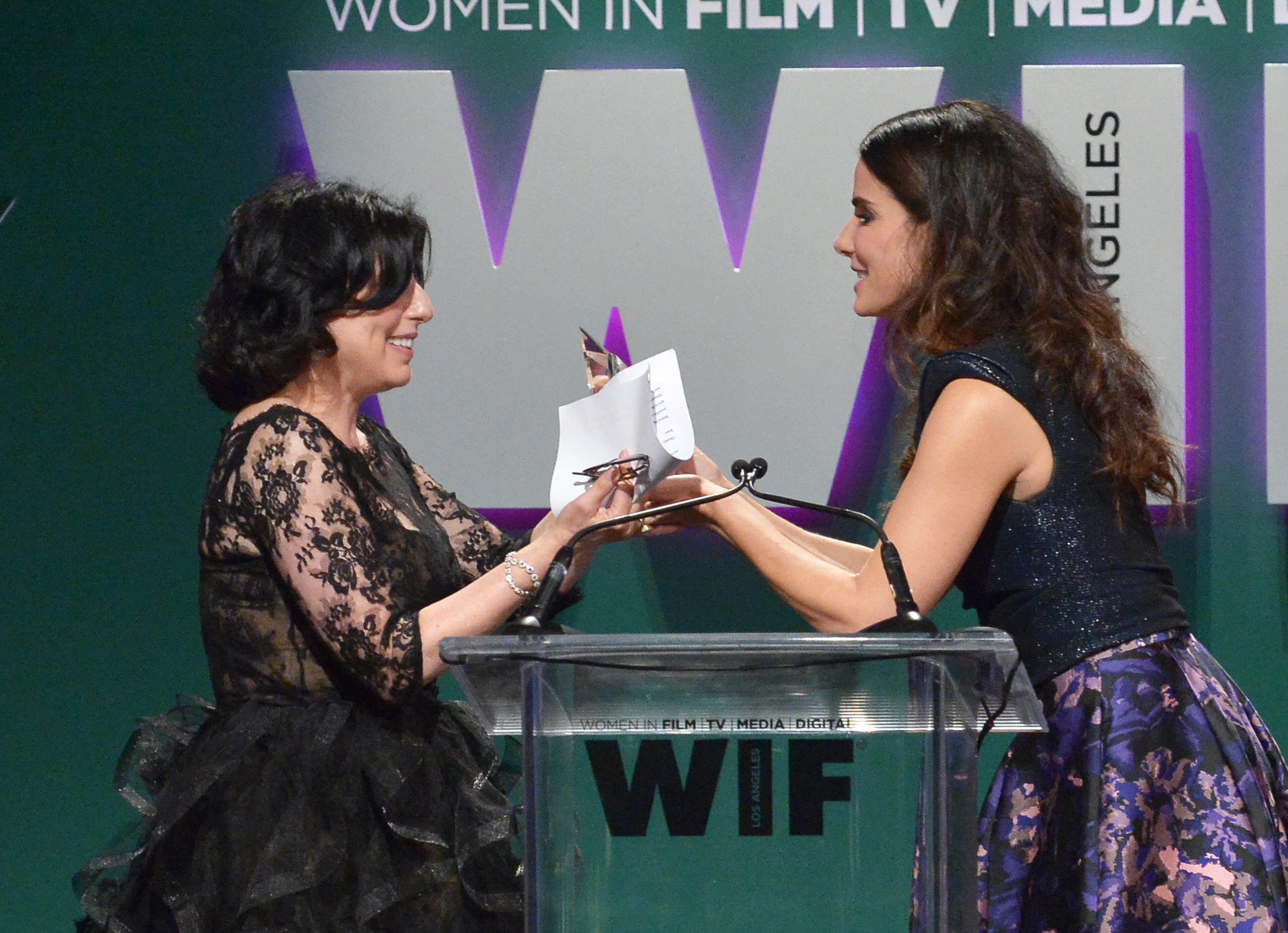 CENTURY CITY, CA - JUNE 16: Honoree Sue Kroll (L) accepts The Tiffany & Co. / Bruce Paltrow Mentorship Award from actress Sandra Bullock onstage during the Women In Film 2015 Crystal + Lucy Awards Presented by Max Mara, BMW of North America, and Tiffany & Co. at the Hyatt Regency Century Plaza on June 16, 2015 in Century City, California. (Photo by Charley Gallay/Getty Images for Women In Film)