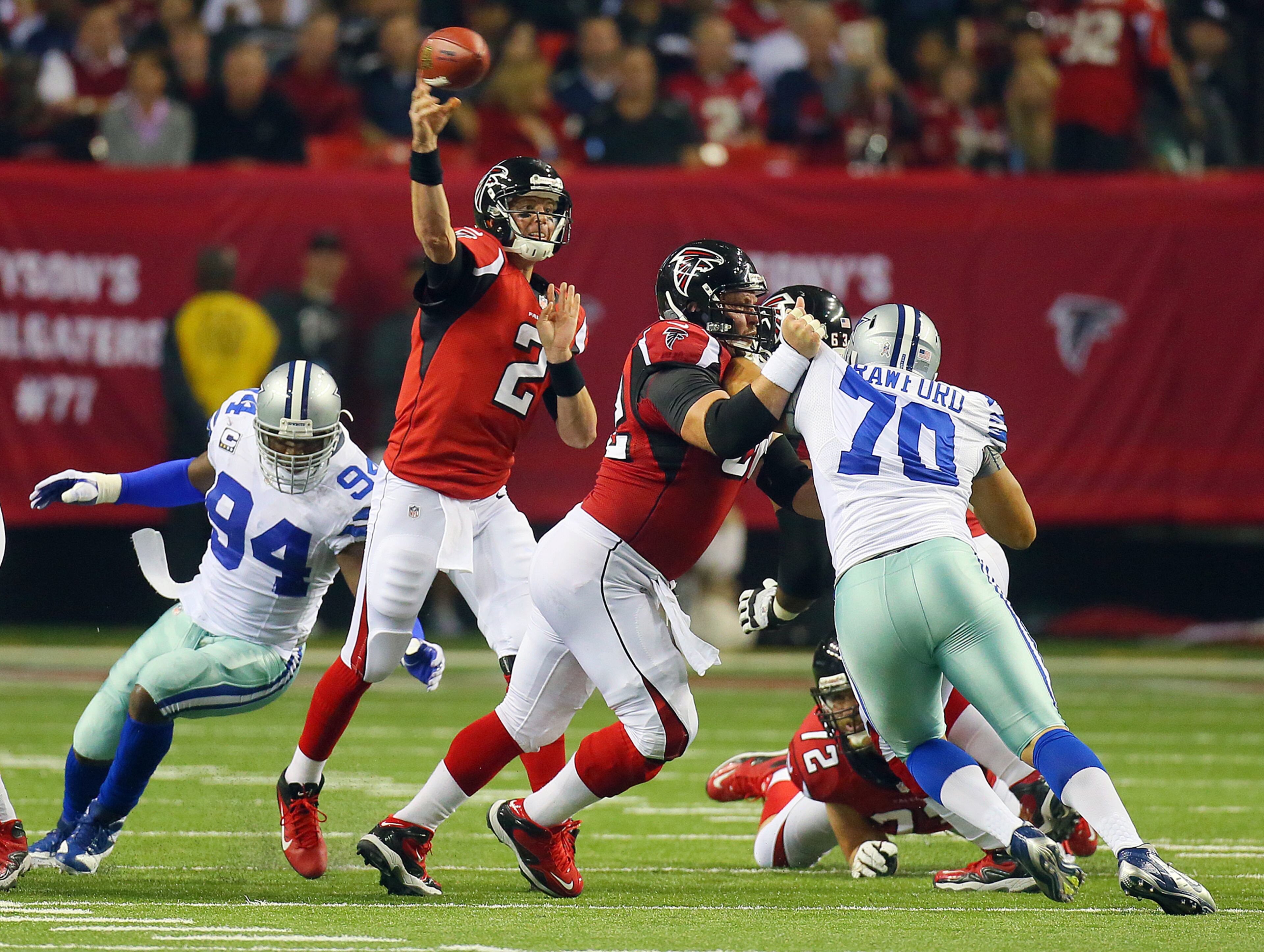 Falcons QB Matt Ryan just gets off a pass thanks to the protection from center Todd McClure. CURTIS COMPTON / CCOMPTON@AJC.COM