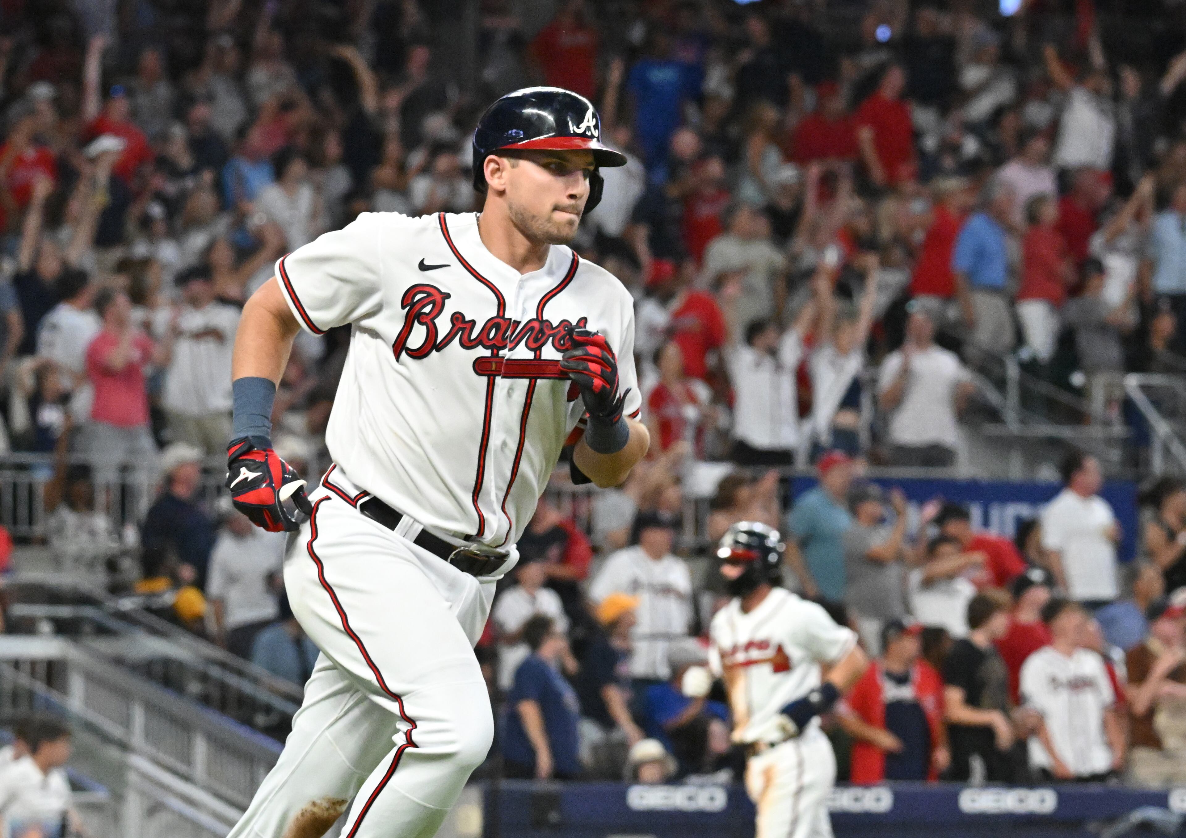 Atlanta Braves' third baseman Austin Riley (27) hits two run home run to score Atlanta Braves' shortstop Dansby Swanson (background) in the 4th inning at Truist Park on Saturday, July 23, 2022. (Hyosub Shin / Hyosub.Shin@ajc.com)