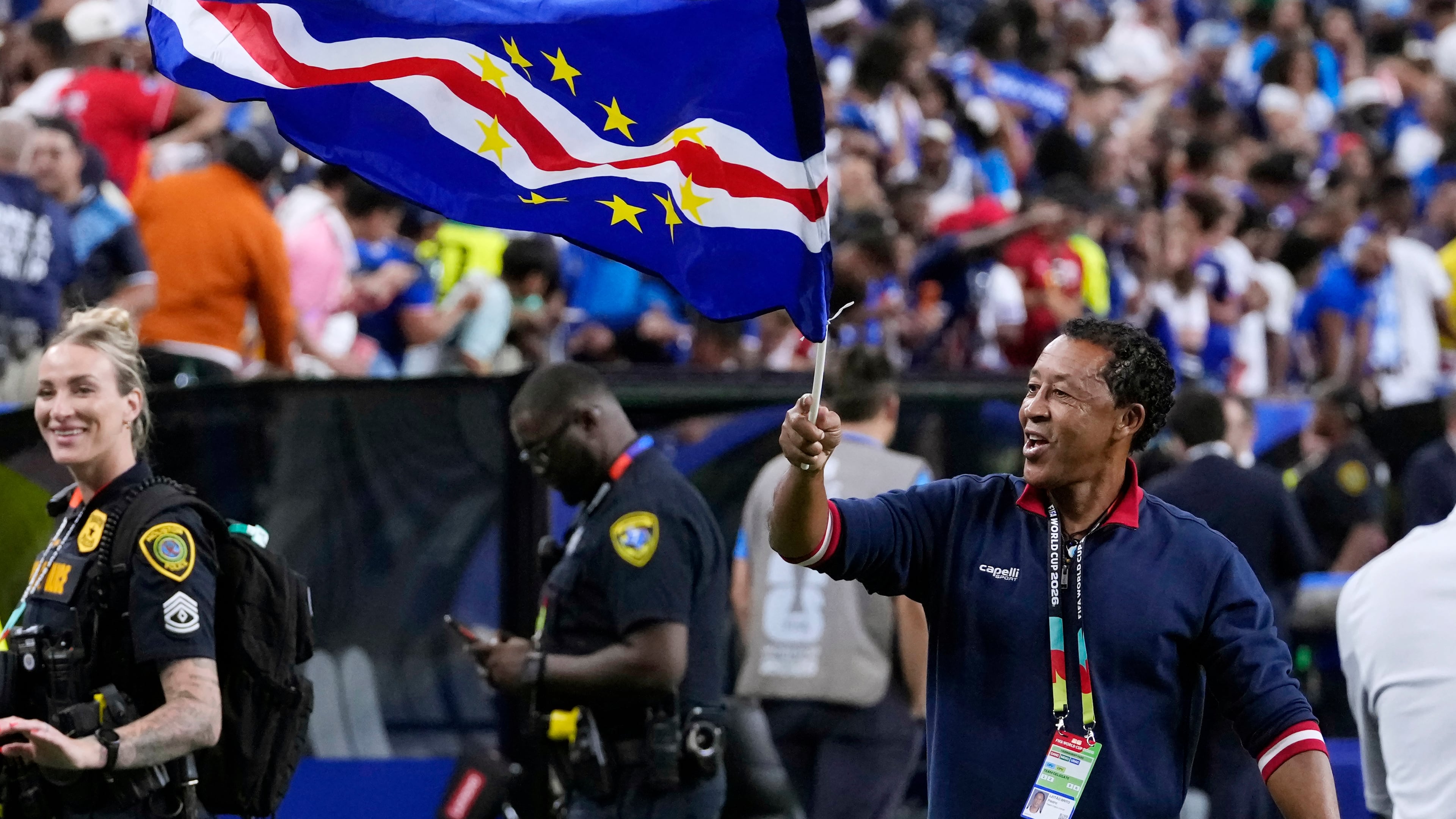 Cape Verde head coach Bubista waves the flag as he celebrates with fans after their 0-0 draw against Saudi Arabia after the World Cup Group H soccer match in Houston, Friday, June 26, 2026. (AP Photo/David J. Phillip)