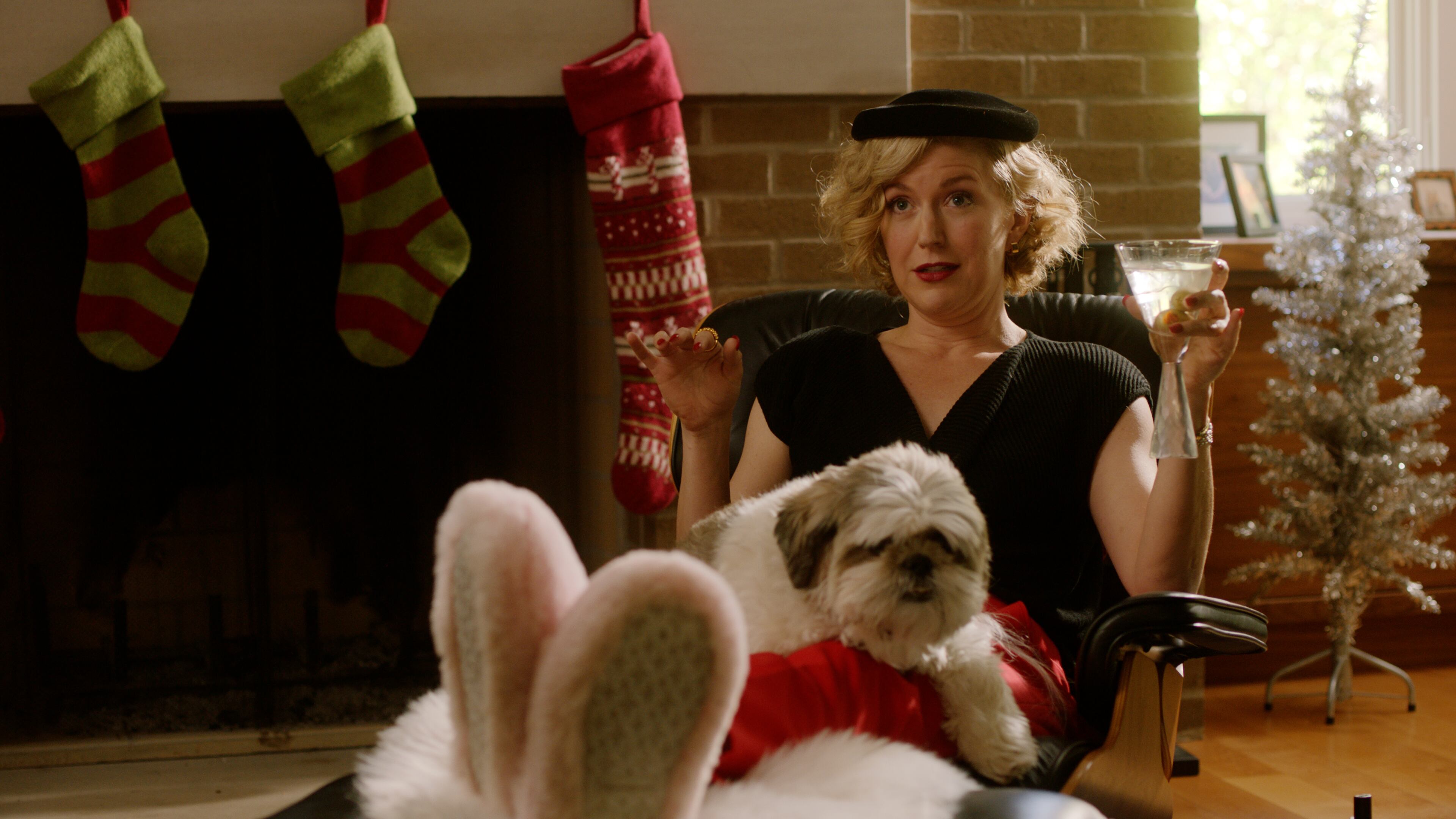 “Christmas with Jerks” writer, co-director and lead actor Leanna Adams in a scene with Mickey the dog.
