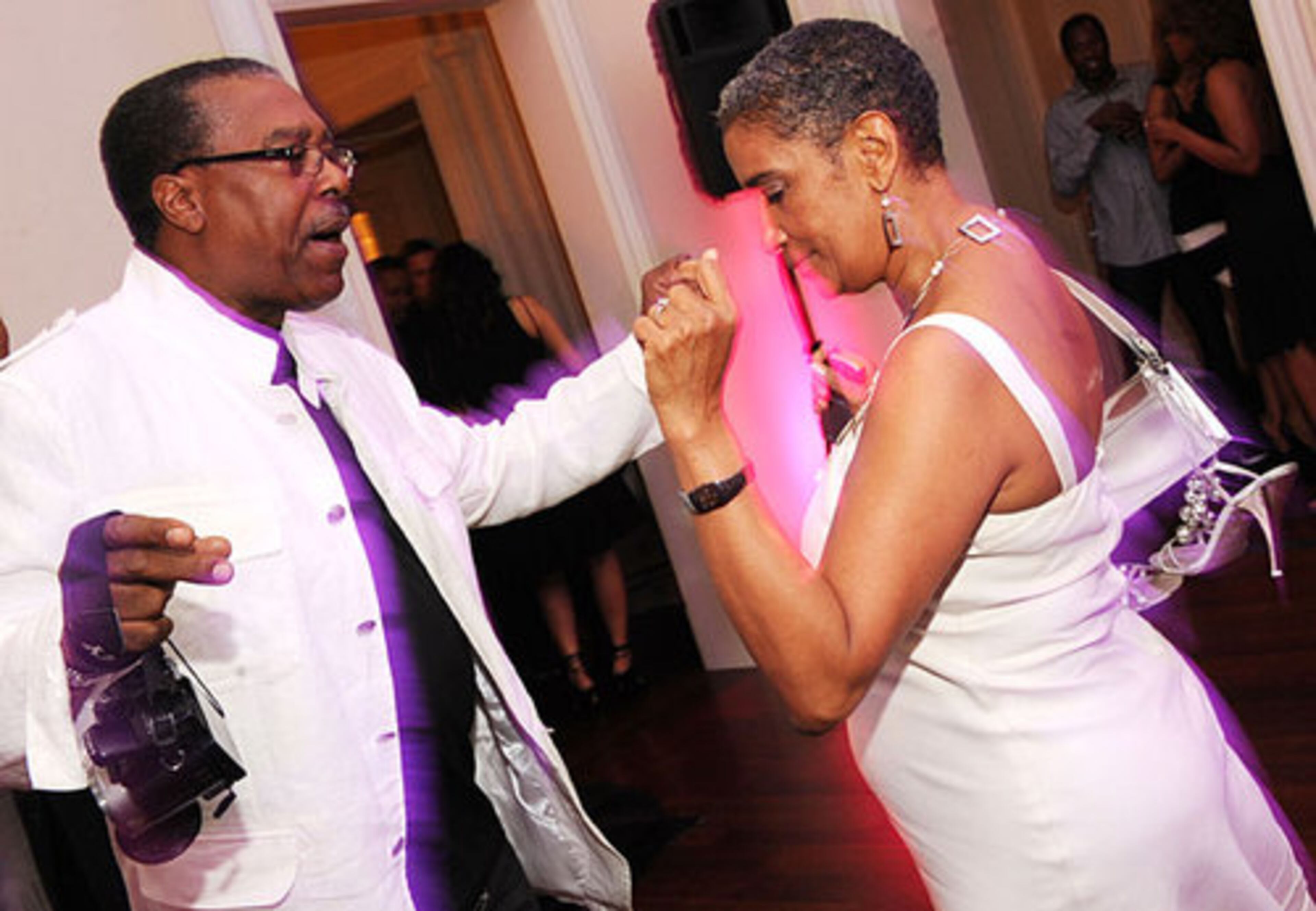 Culture affairs director Camille Love dances with Stanley Clemonds.