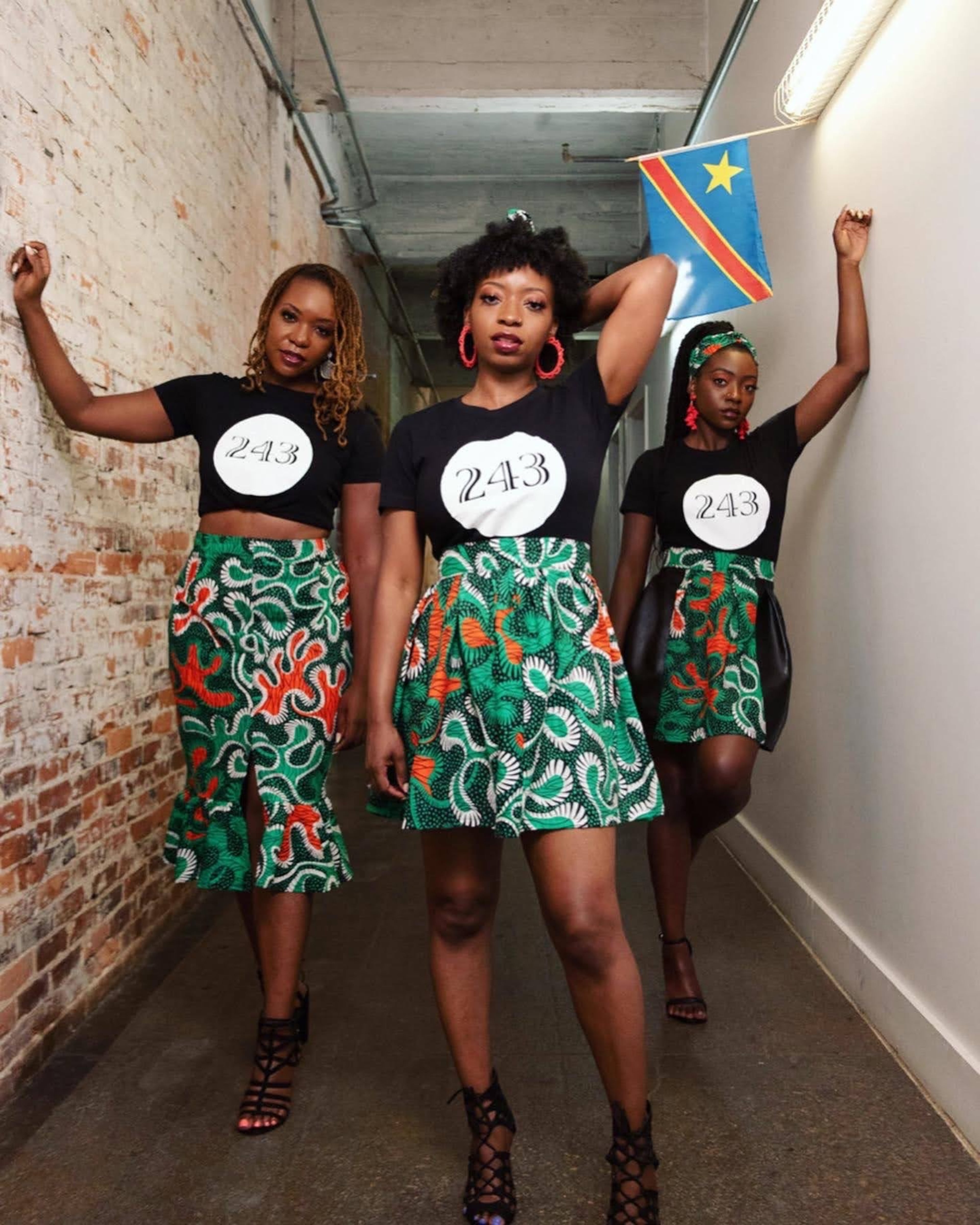 Nina Maketo Ford (from left) and her sisters Melia Maketo Russell and Miranda Maketo Cook show off their Congolese pride beneath the African country's flag. Ford is the first member of her family born in the United States. (Courtesy of Nina Maketo Ford)