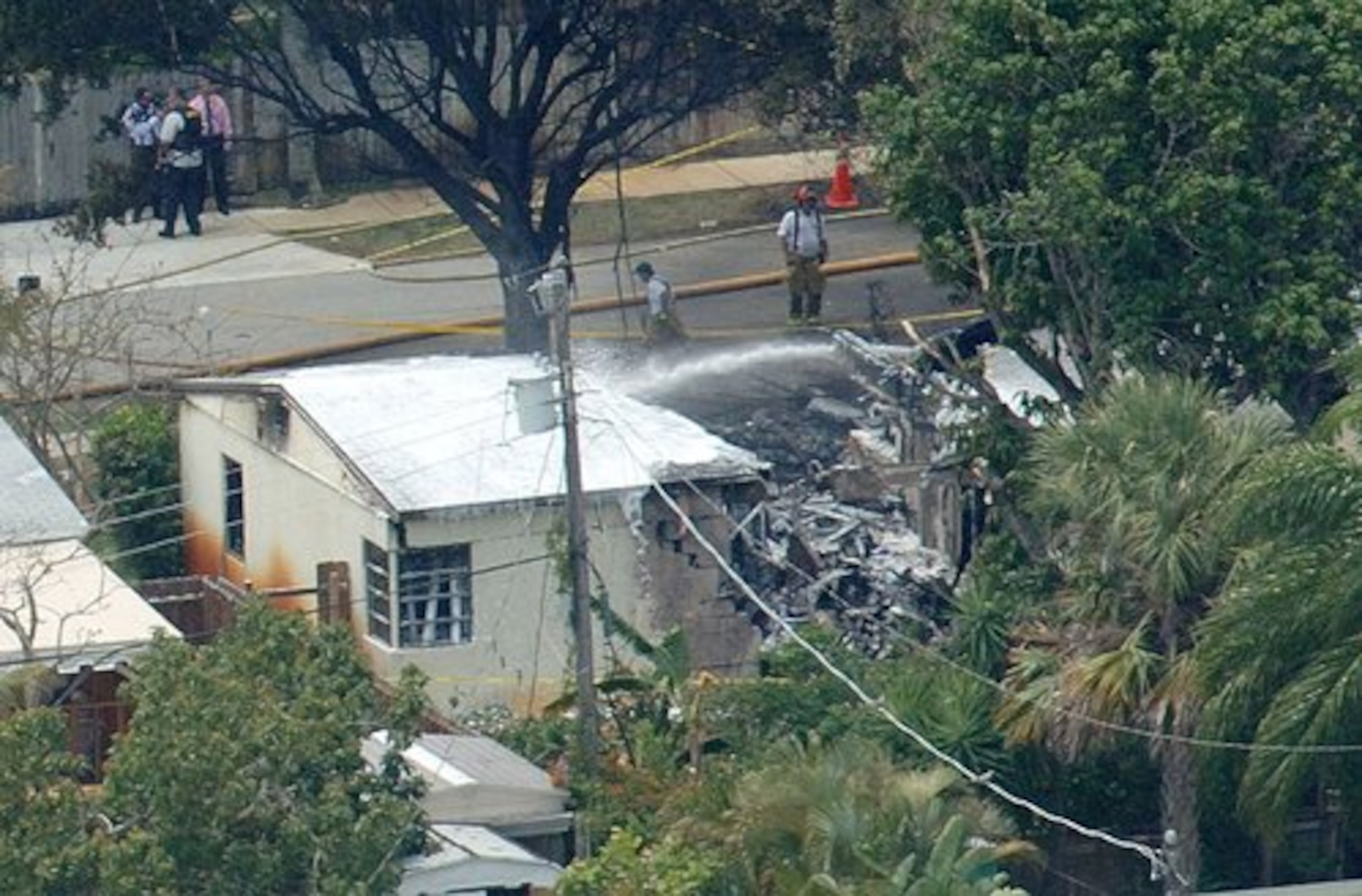 Firefighters hose down the wreckage after the crash.