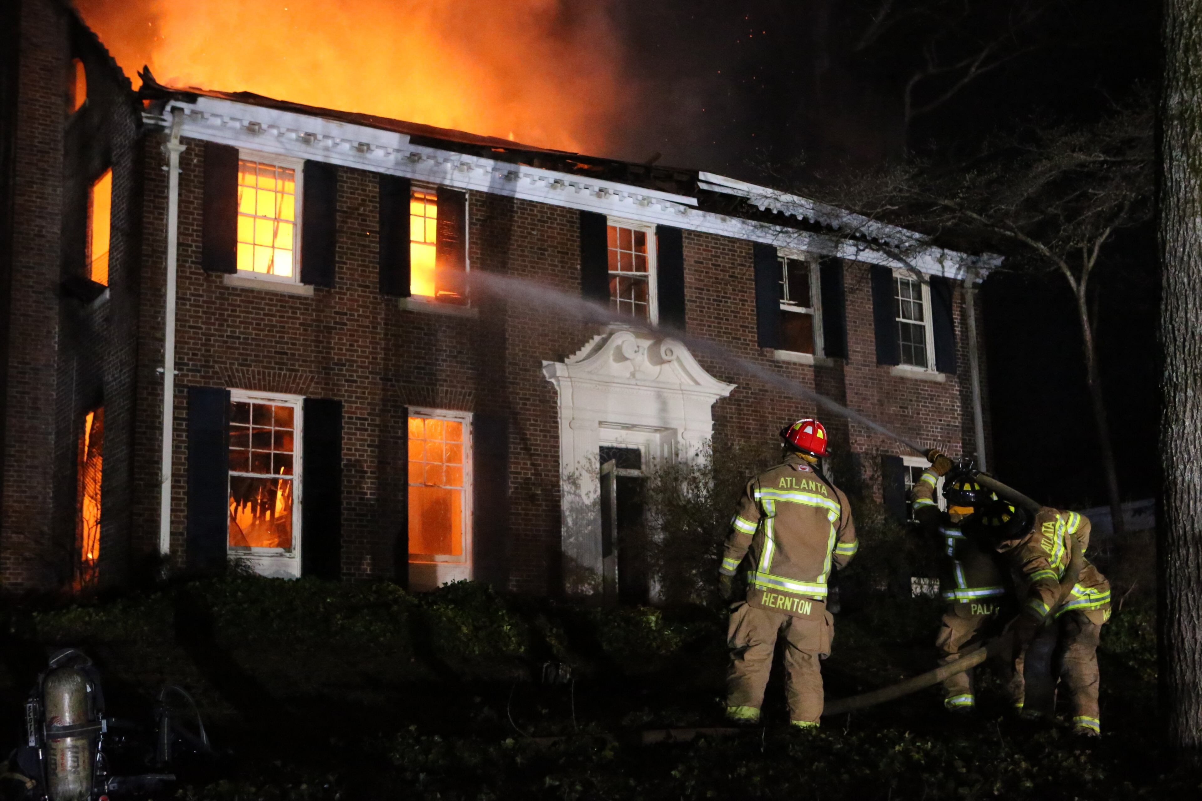 Two firefighters suffered minor injuries battling a Tuesday night blaze that destroyed a large, vacant home in the Druid Hills neighborhood of northeast Atlanta.