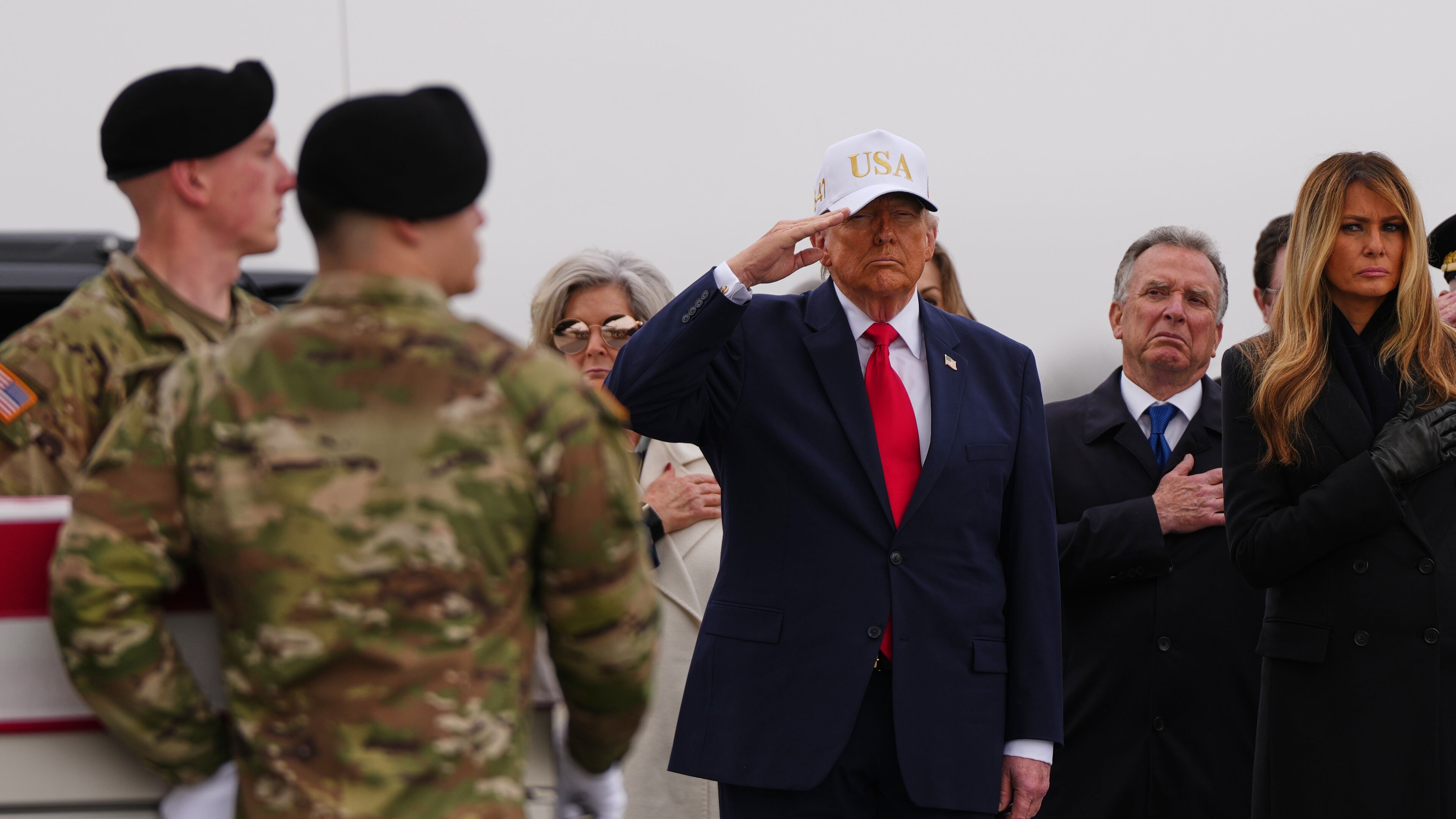 President Donald Trump salutes as an Army carry team moves the flag-draped transfer case containing the remains of U.S. Army Reserve Sgt. 1st Class Noah Tietjens, 42, of Bellevue, Neb., who was killed in a drone strike at a command center in Kuwait after the U.S. and Israel launched its military campaign against Iran, during a casualty return Saturday, March 7, 2026, at Dover Air Force Base, Del. At right is first lady Melania Trump and White House Special Envoy to the Middle East Steve Witkoff. (AP Photo/Julia Demaree Nikhinson)