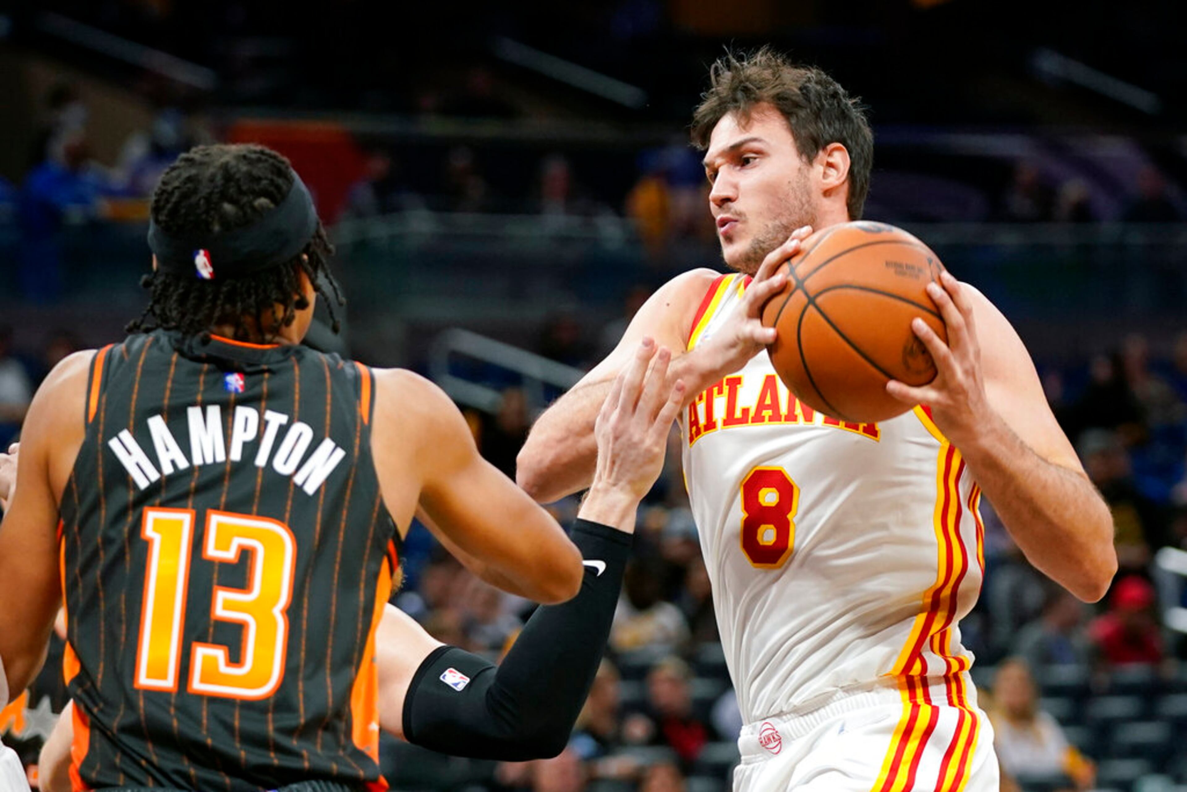 Atlanta Hawks forward Danilo Gallinari (8) tries to get past Orlando Magic guard R.J. Hampton (13) for a shot during the first half of an NBA basketball game, Wednesday, Dec. 15, 2021, in Orlando, Fla. (AP Photo/John Raoux)