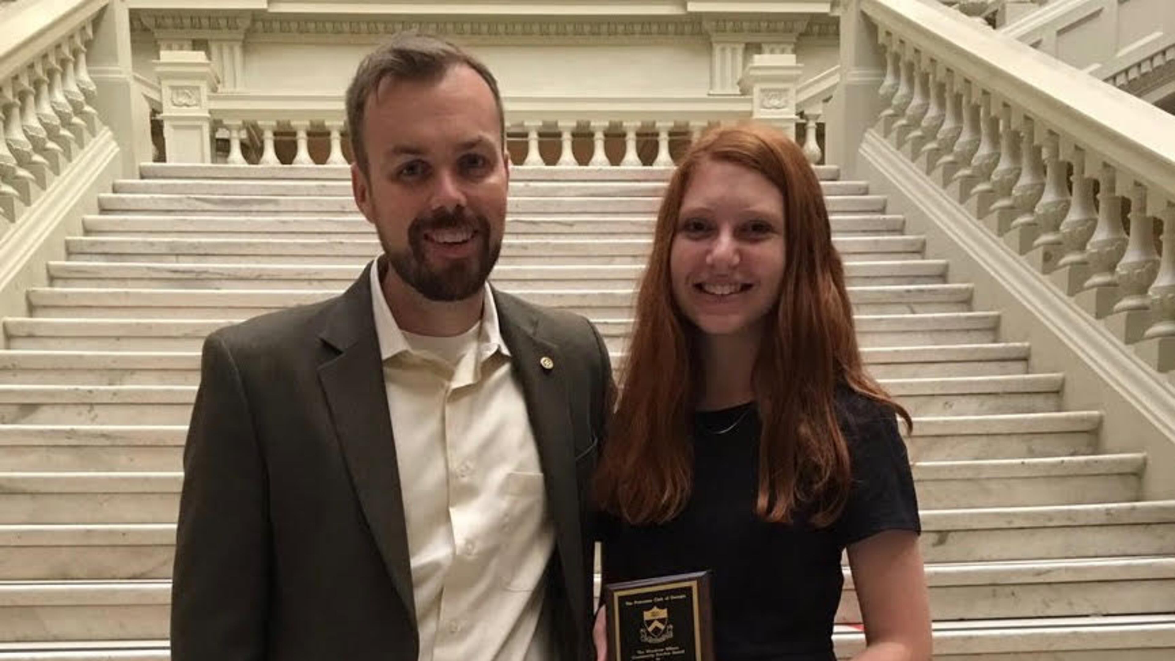 Riverwood International Charter School Principal Charles Gardner (left) stood with his student Dori Balser on the interior steps of the Georgia State Capitol after Balser received the 2017 Woodrow Wilson Community Service award from the Princeton Club in recognition of her outstanding service to her community.