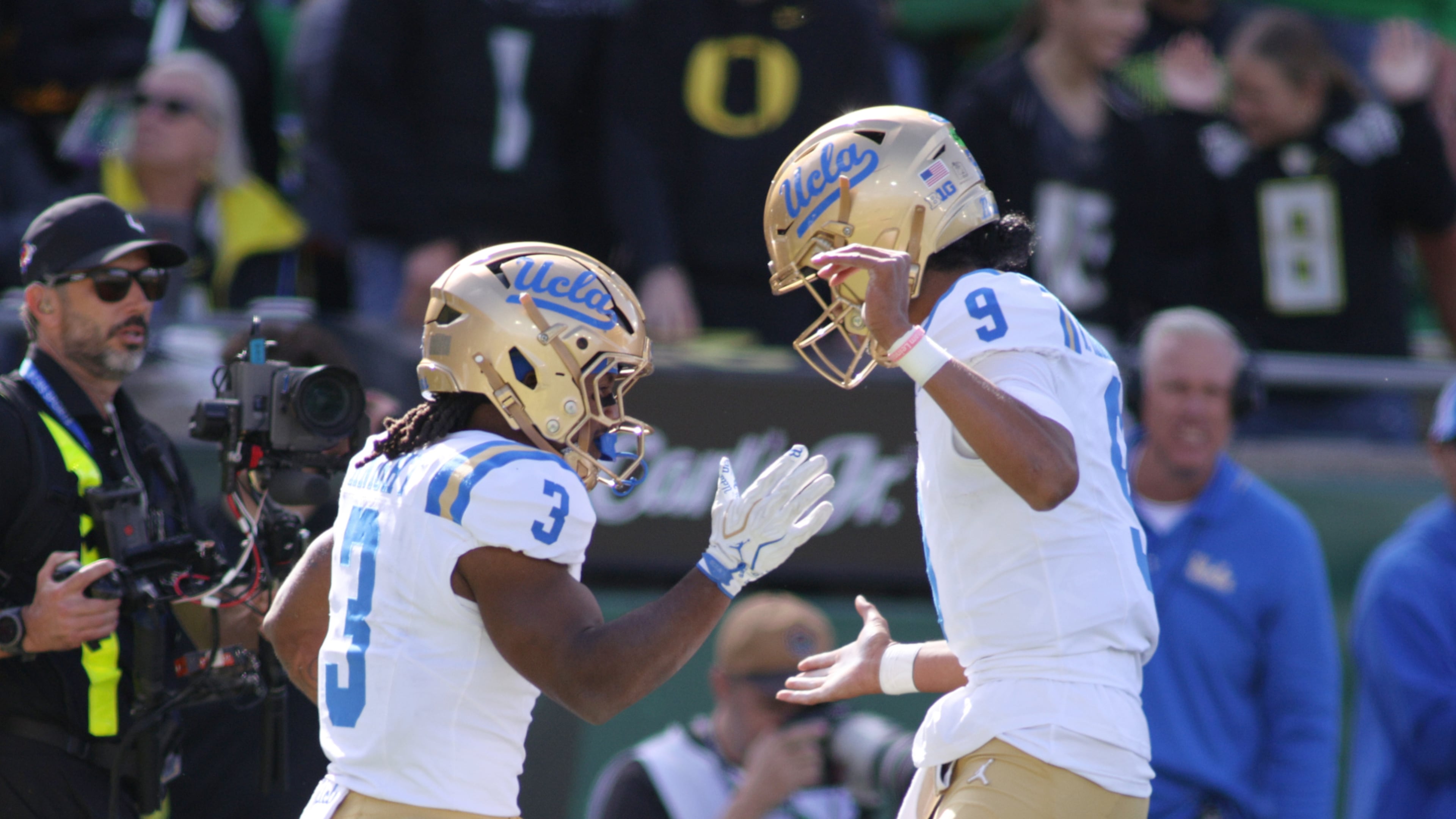 UCLA quarterback Nico Iamaleava (9) congratulates running back Wayne Knight (3) on a touchdown during the first half of an NCAA college football game against Oregon, Saturday, Oct. 10, 2026, in Eugene, Ore. (AP Photo/Lydia Ely)