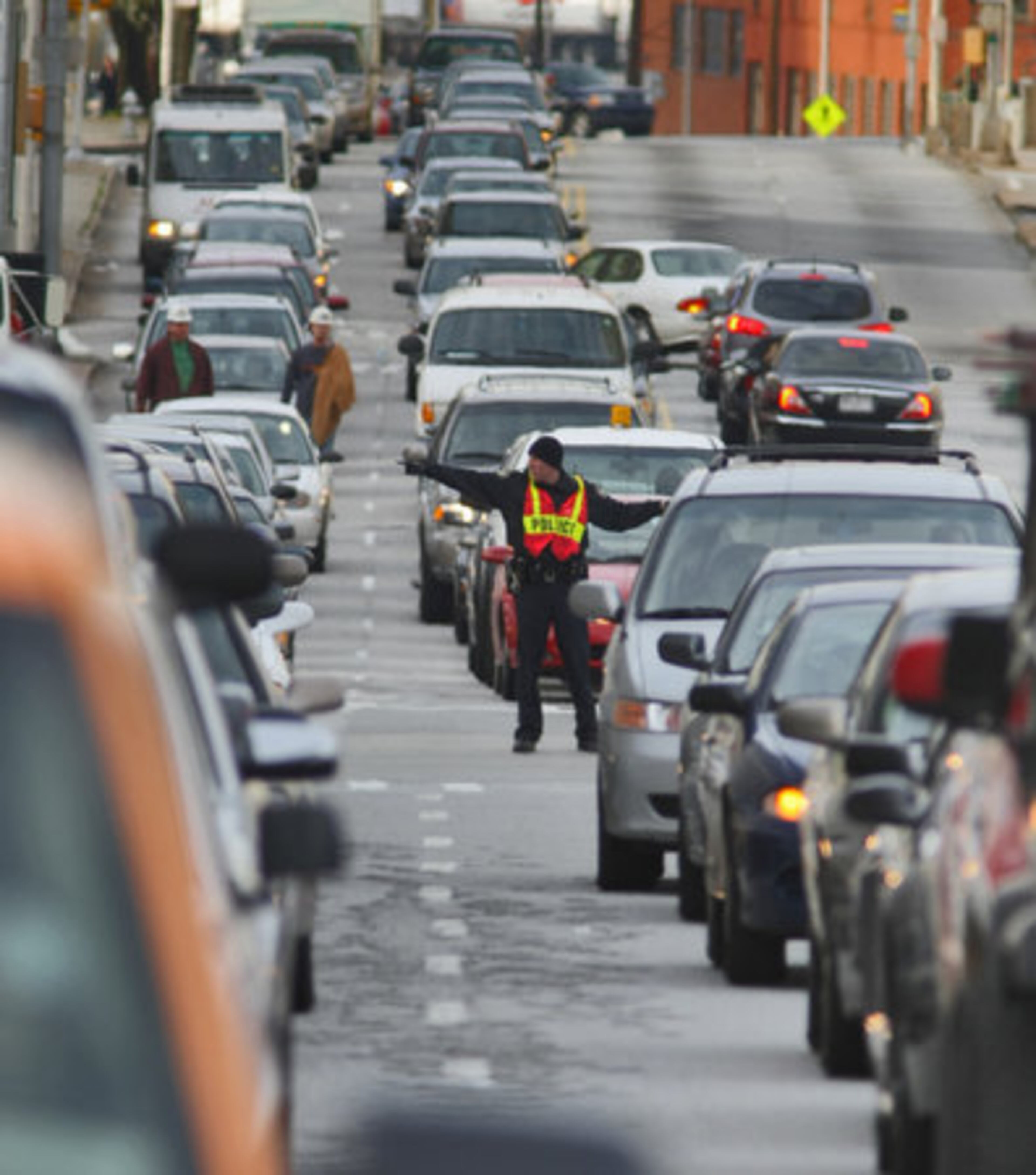 Monday, March 17: An Atlanta police officer directed traffic downtown. Downed traffic lights made commuting difficult downtown.