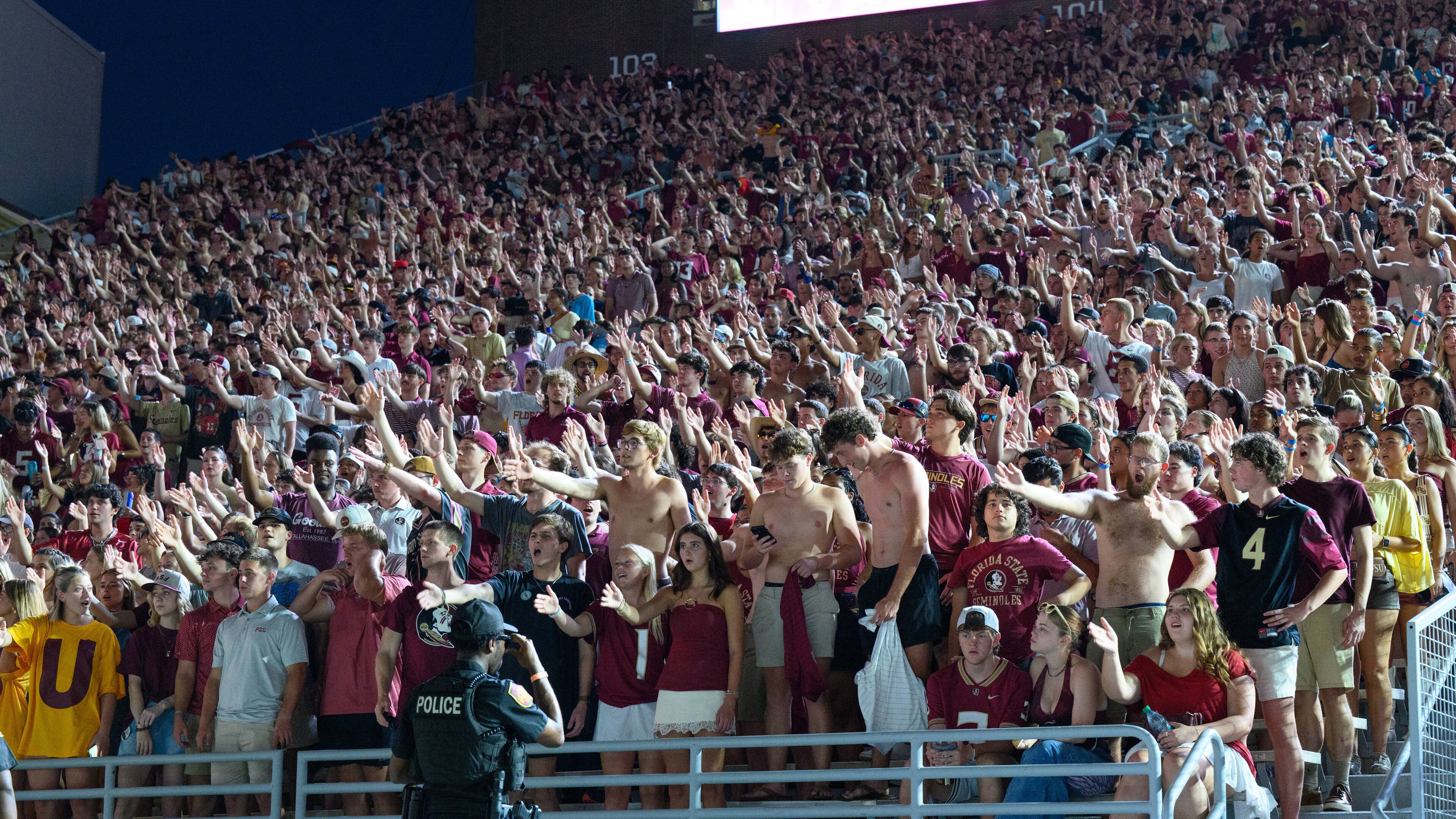Florida State students perform the tomahawk chop during a stadium-wide power outage before an NCAA college football game against SMU, Monday, Sept. 7, 2026, in Tallahassee, Fla. (AP Photo/Noah Lantor)