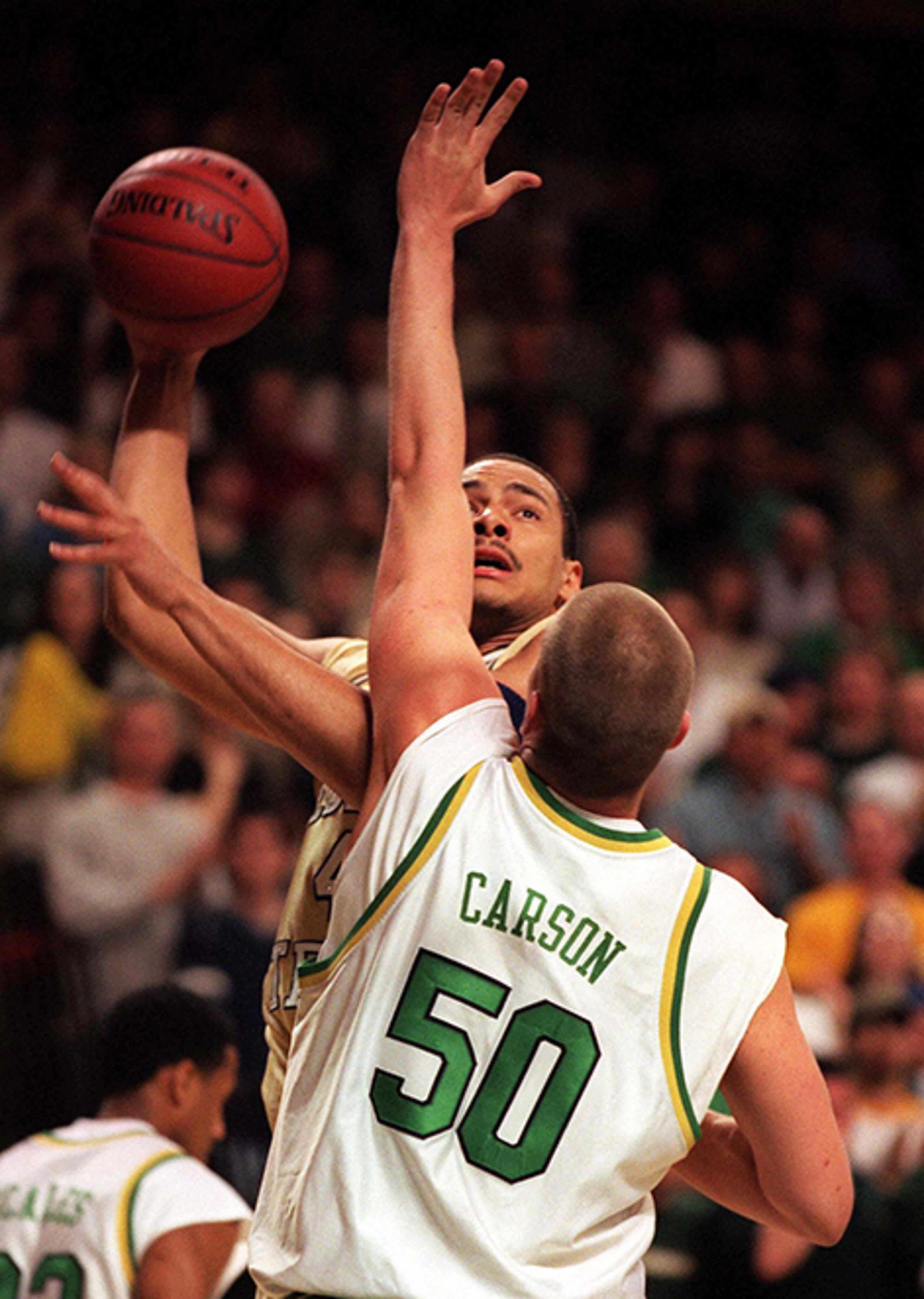 Georgia Tech's Alvin Jones shoots over Oregon's Mike Carson in the first round of the NIT in Eugene, Ore., Wednesday evening, March 10, 1999. (AP Photo/The Register-Guard/Thomas Boyd)