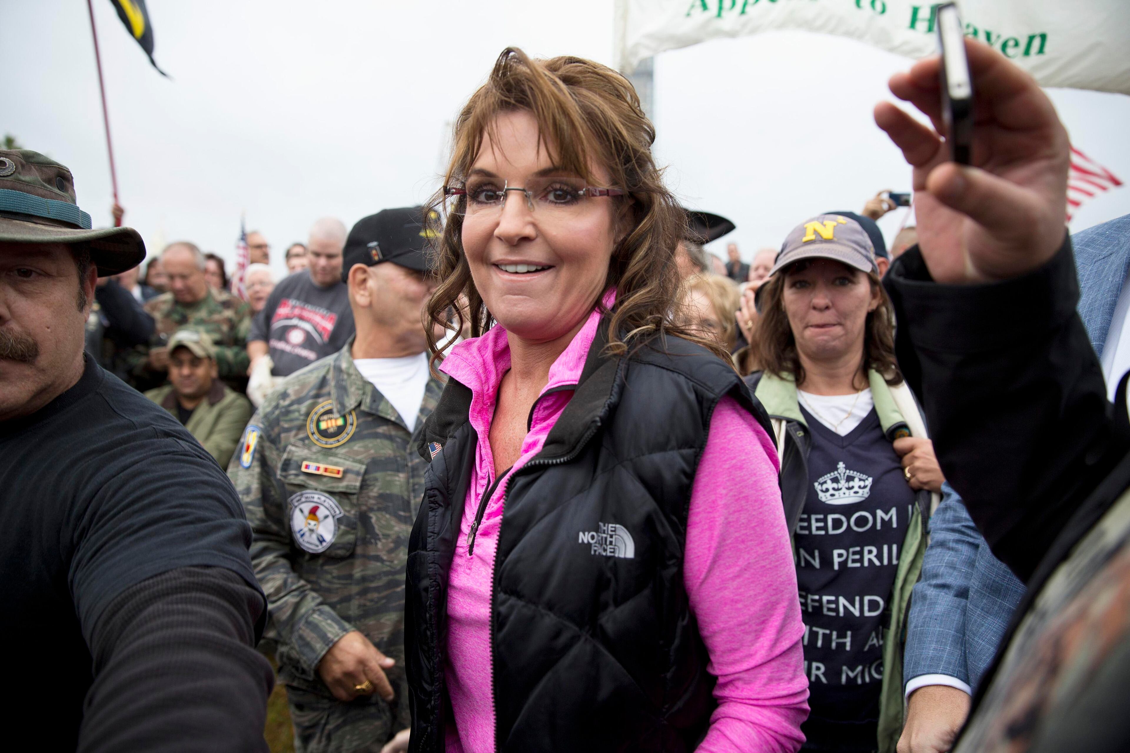 Former Alaska Governor Sarah Palin arrives at the "Million Vet March on the Memorials" at the U.S. National World War II Memorial in Washington October 13, 2013. The group was organized in protest of to the Obama administration's decision to close the memorial and bar entry to World War Two vets who had traveled to visit it during the partial government shut down. REUTERS/Joshua Roberts