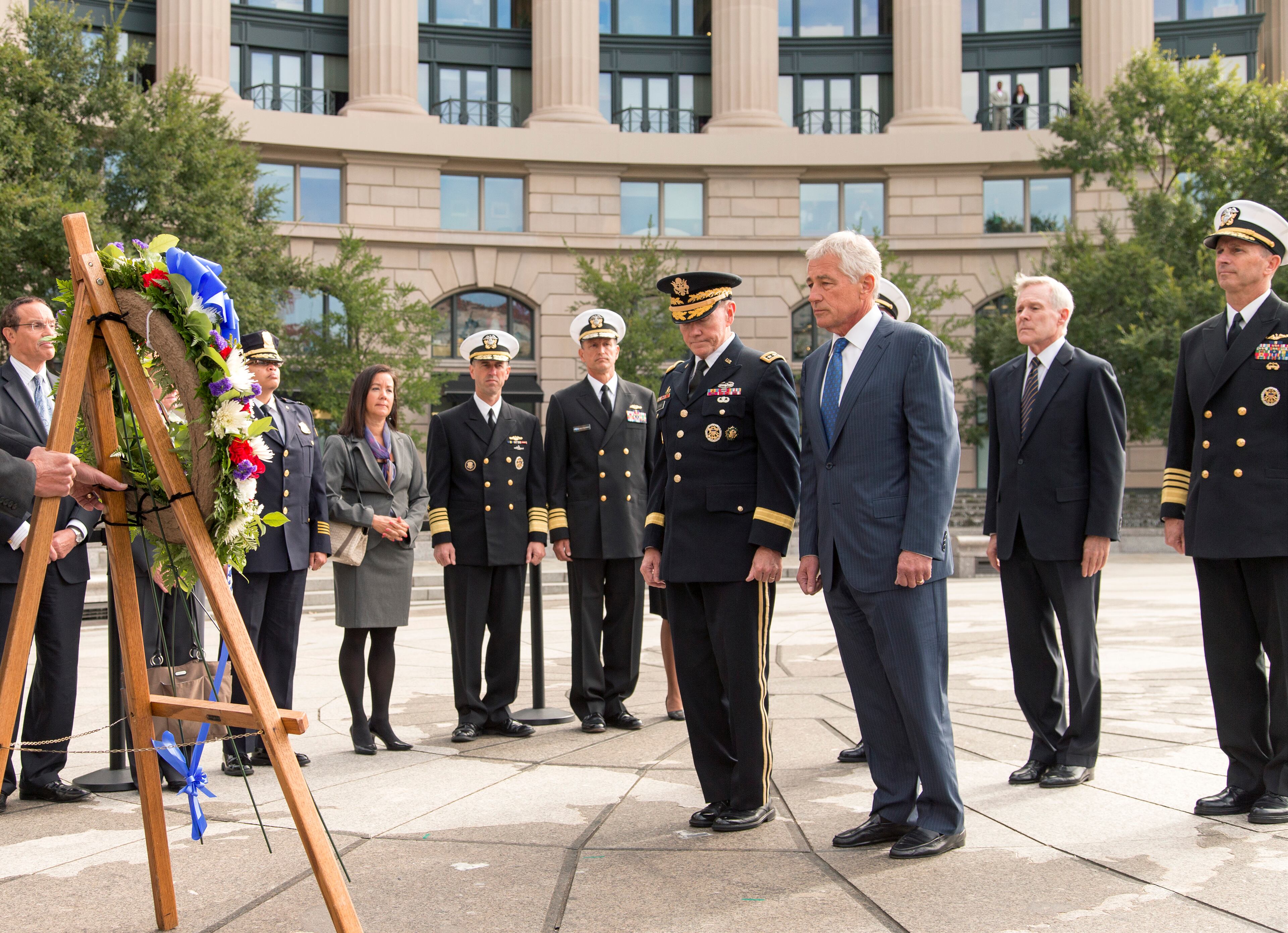 Defense Secretary Chuck Hagel, center right, and Joint Chiefs Chairman Gen. Martin Dempsey, center left, lead a delegation at the Navy Memorial in Washington to remember the victims of Monday's deadly shooting at the Washington Navy Yard, Tuesday, Sept. 17, 2013. At far right is Chief of Naval Operations Adm. Jonathan Greenert, with Secretary of the Navy Ray Mabus, second from right. (AP Photo/J. Scott Applewhite)