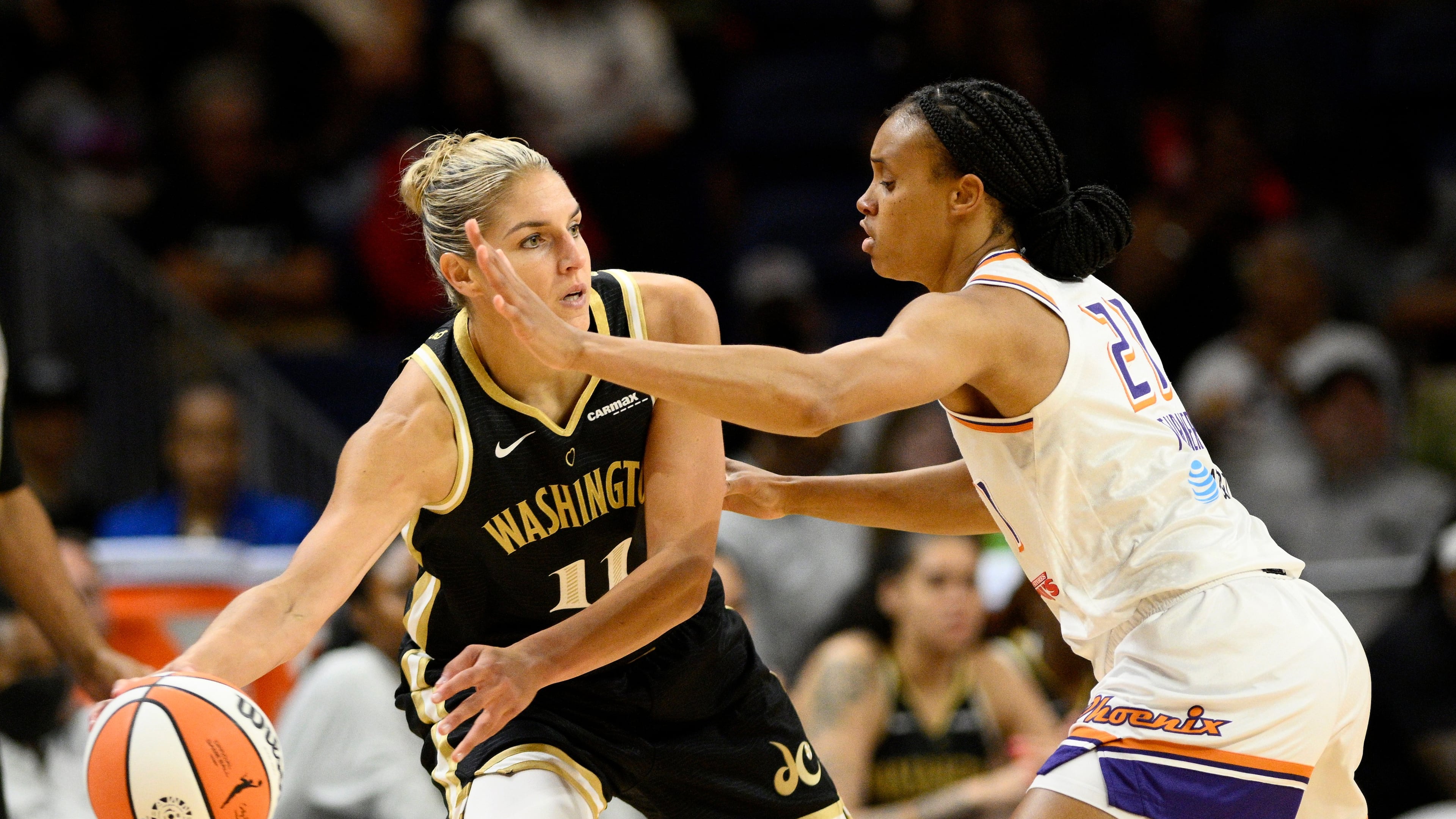 FILE - Washington Mystics forward Elena Delle Donne (11) looks to pass the ball as Phoenix Mercury forward Brianna Turner (21) defends during the first half of a WNBA basketball game, June 16, 2023, in Washington. (AP Photo/Nick Wass, File)