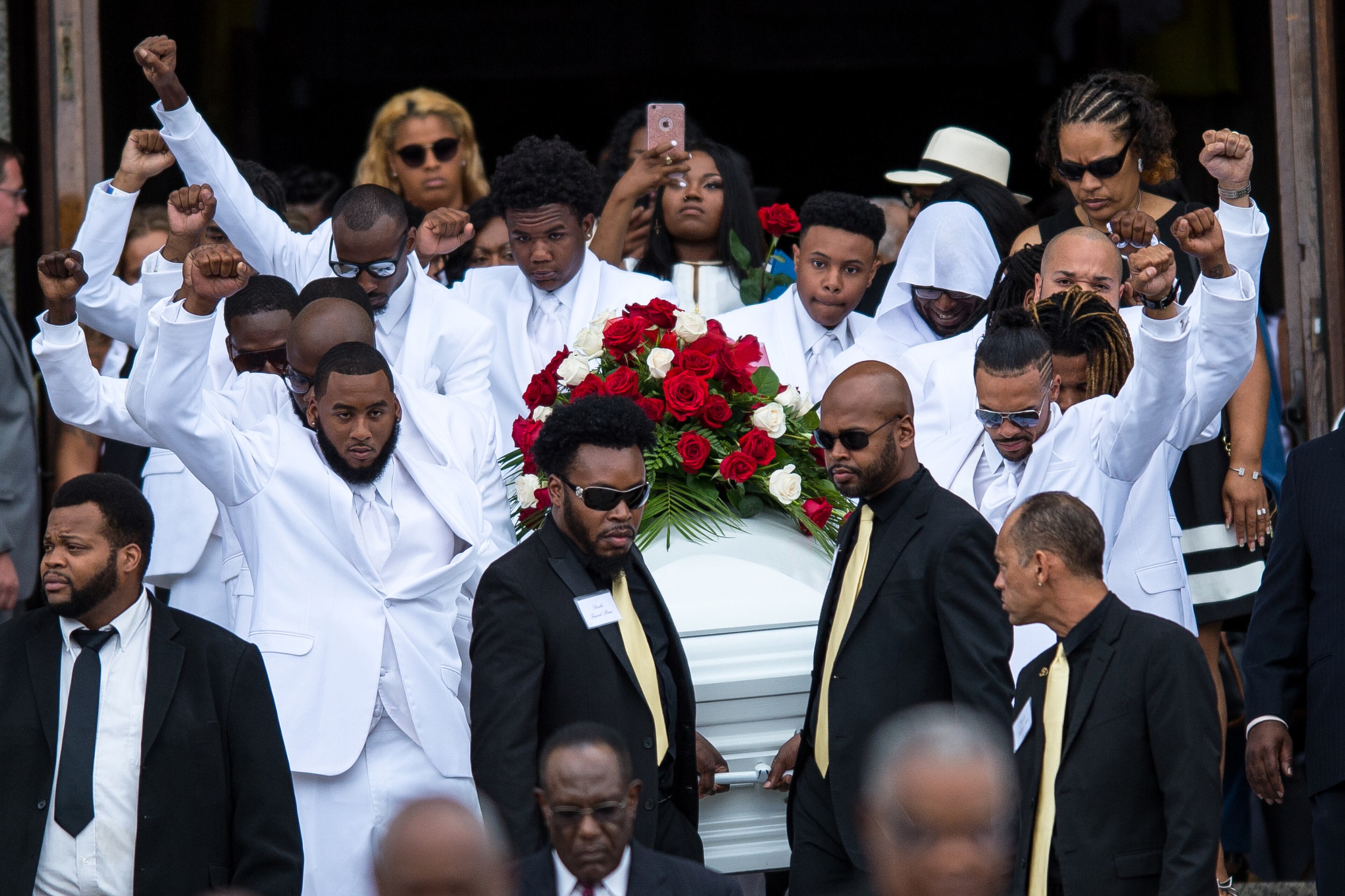 Pallbearers raise their fists in the air as they bring the casket carrying Philando Castile back to the horse-drawn carriage following Castile's funeral in St. Paul, Minn., on Thursday, July 14, 2016. (Aaron Lavinsky/Minneapolis Star Tribune/TNS)