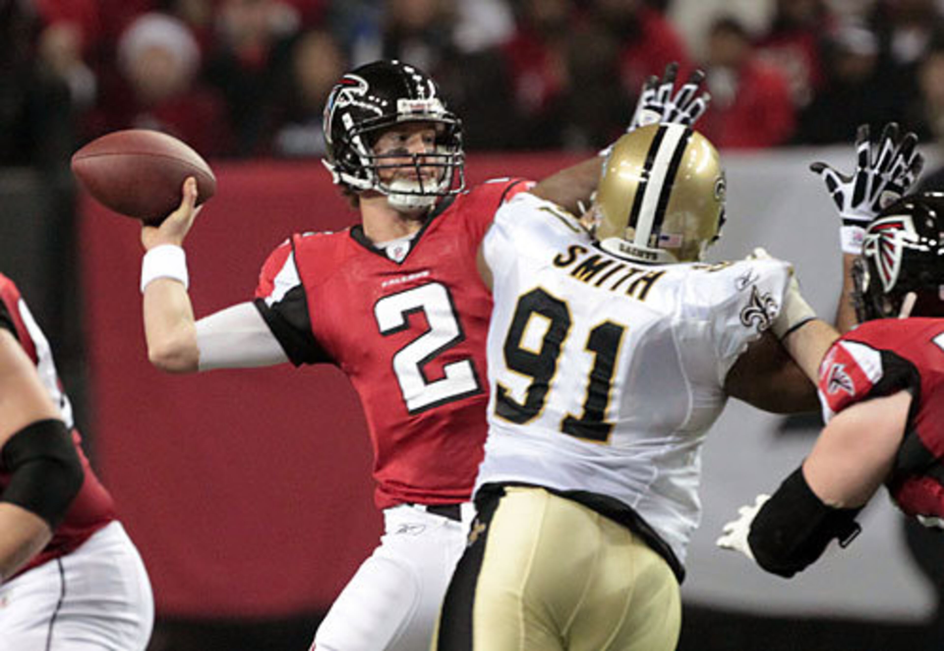 Falcons quarterback Matt Ryan (2) barely gets the ball off as New Orleans Saints defensive end Will Smith (right) defends.
