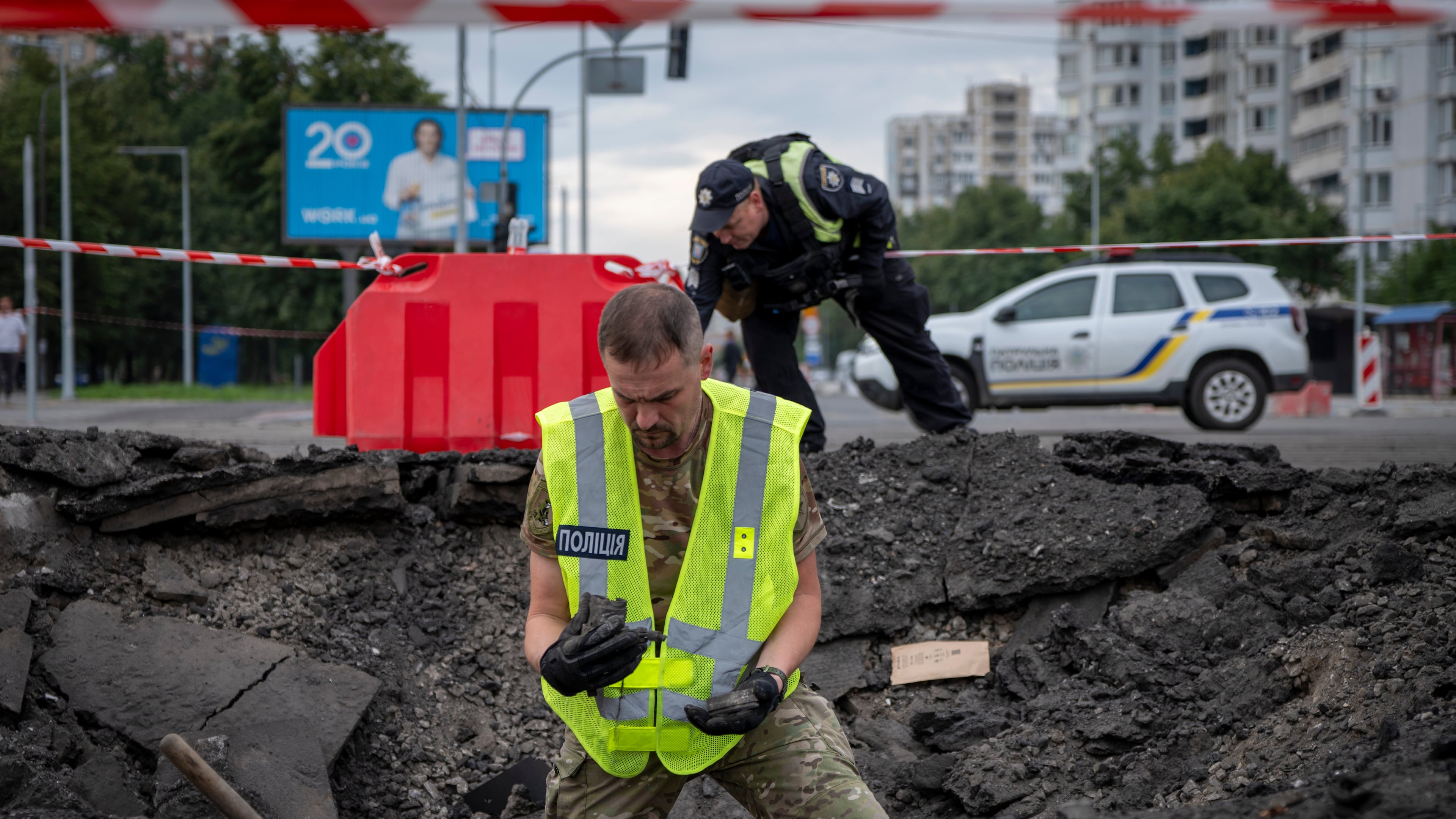 A sapper examines the impact site of a Russian missile in a residential area of Kyiv, Saturday, July 11, 2026. (AP Photo/Dan Bashakov)