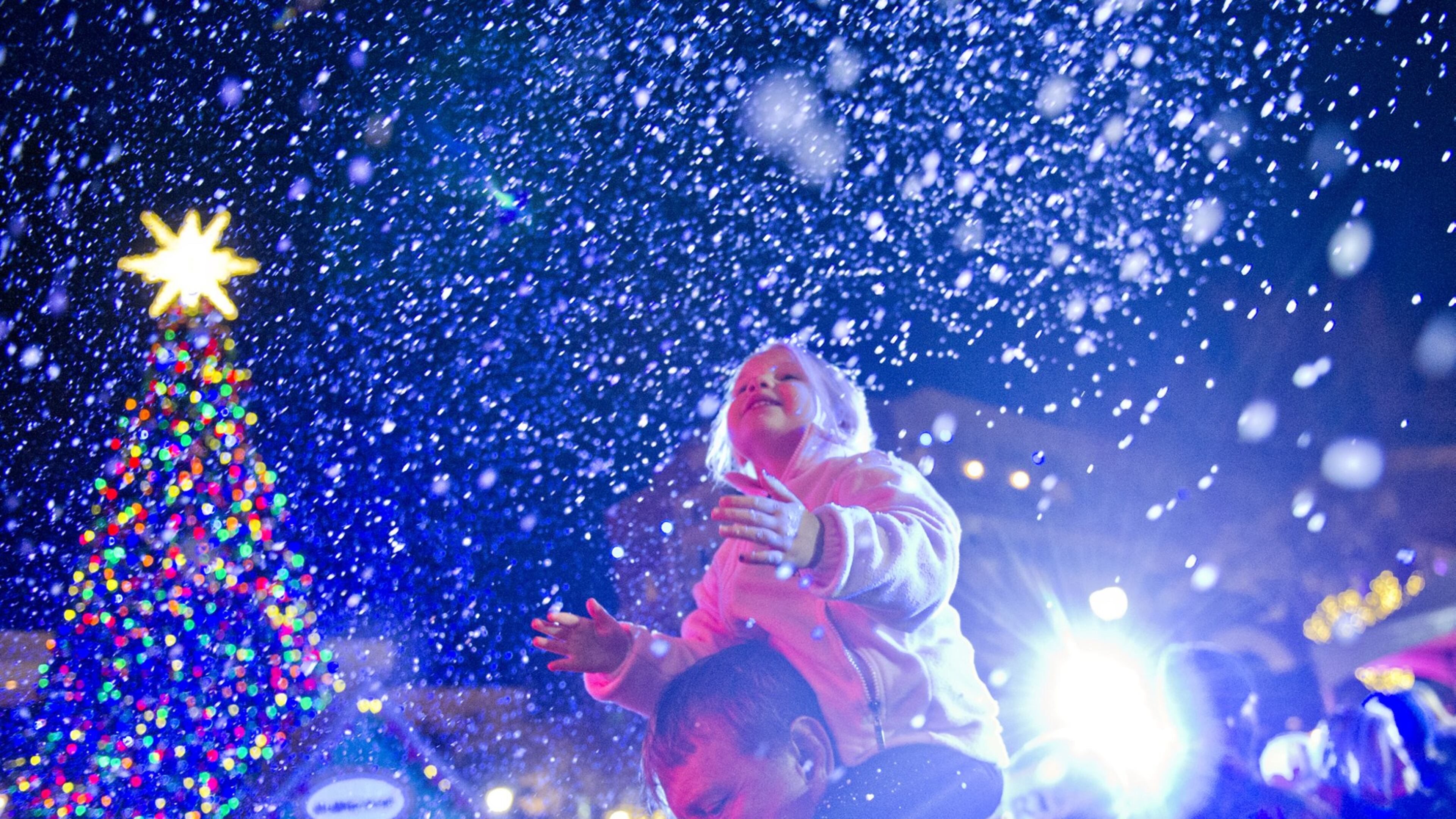 Don Johnson (left) holds his daughter Tyler on his shoulders as snow falls at Atlantic Station in Atlanta during the annual Christmas tree lighting on Nov. 23, 2013. The all-day celebration had live music, arts, live reindeer, delicious winter treats, and activities for the whole family. This year’s tree lighting at Atlantic Station will be Saturday, Nov. 21. JONATHAN PHILLIPS / SPECIAL