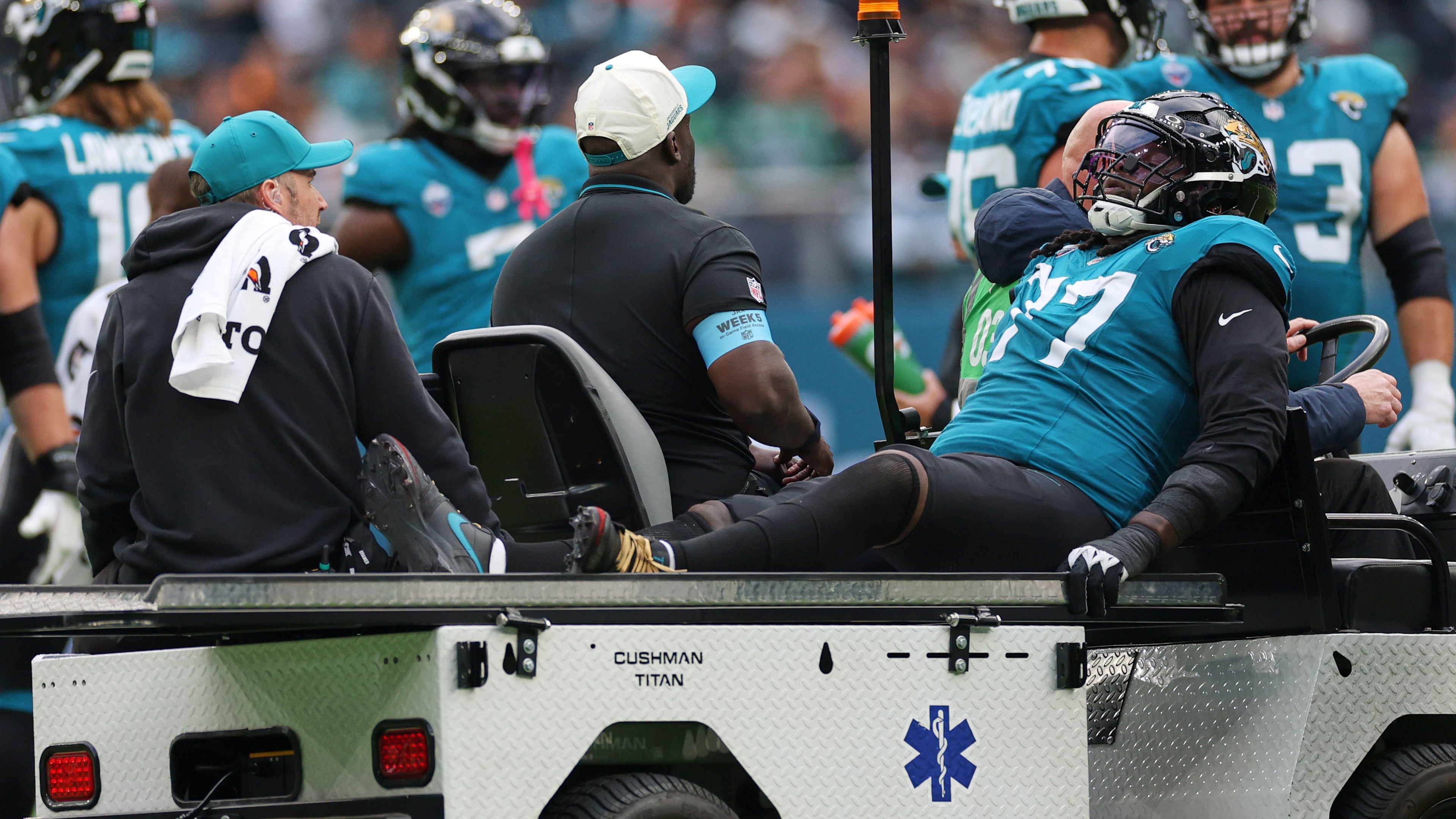 Jacksonville Jaguars offensive tackle Anton Harrison (77) is driven from the field after an injury during an NFL football game against Philadelphia Eagles in London, Sunday, Oct. 11, 2026. (AP Photo/Ian Walton)