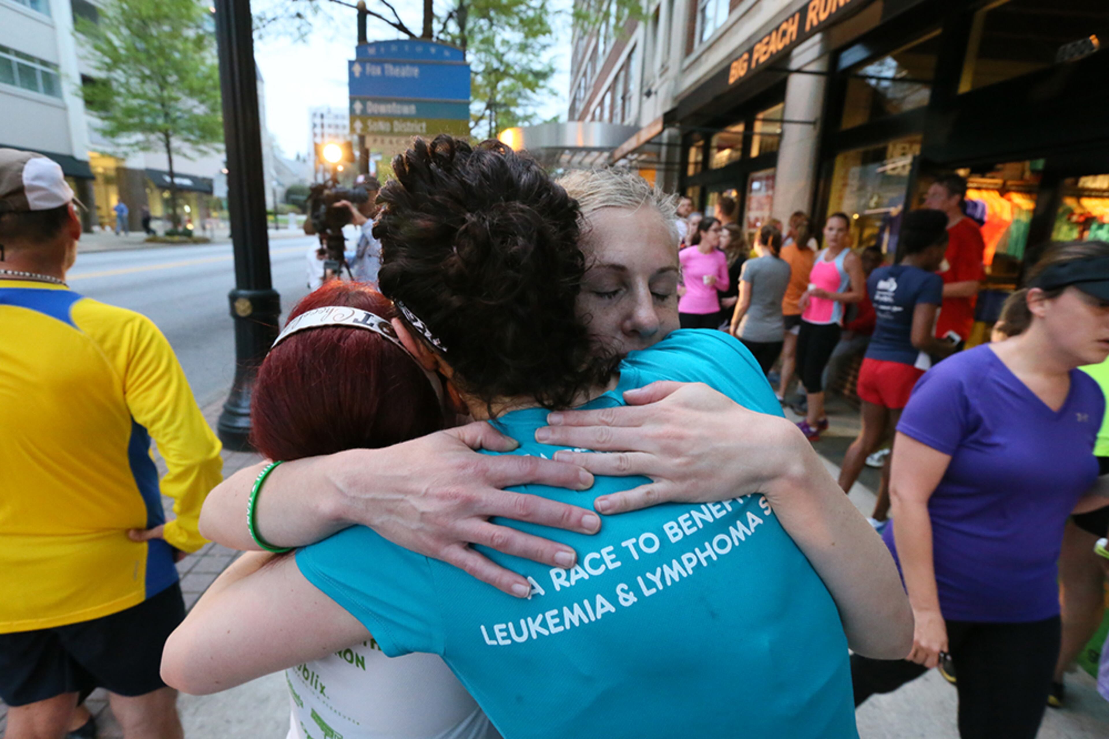 Runners embrace after the tribute run.