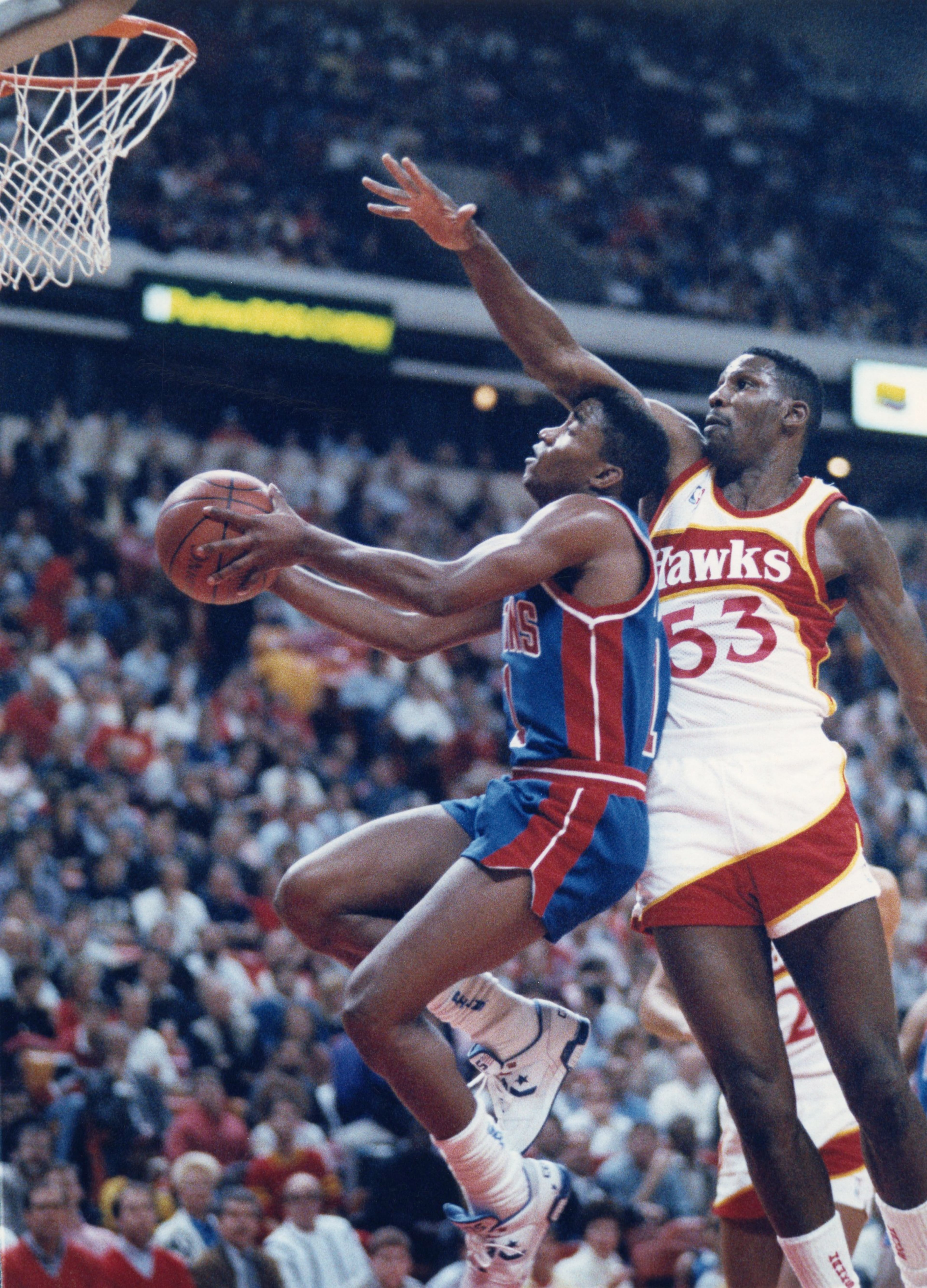 Cliff Levingston (right) of the Hawks defends against Isiah Thomas of the Pistons in 1989. AJC file photo