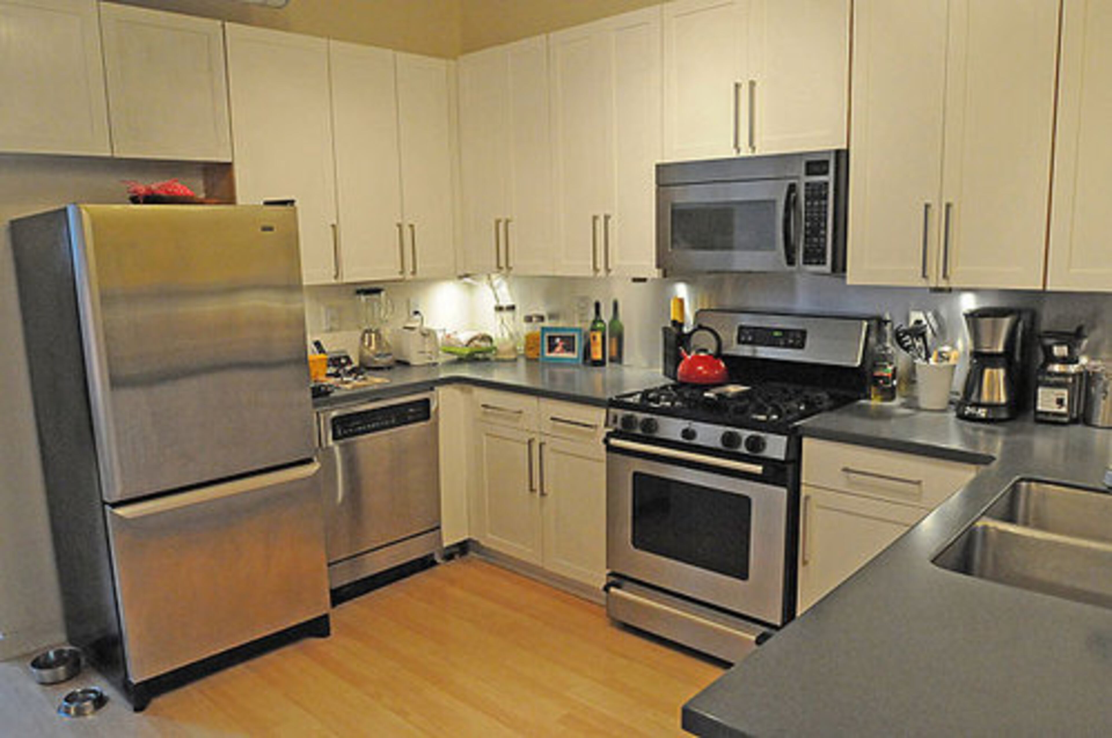 Kitchens feature a breakfast bar area and stained cabinets.