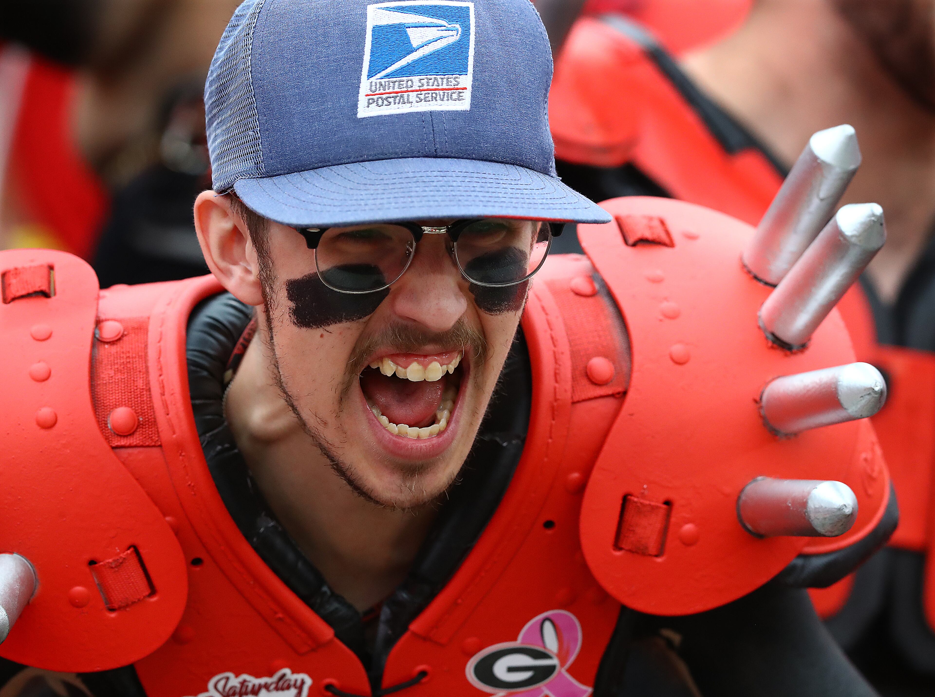 A Georgia fan sports a postal hat for quarterback Stetson Bennett to deliver the mail as he cheers his team taking the field to play Samford in a NCAA college football game on Saturday, Sept. 10, 2022, in Athens. “Curtis Compton / Curtis Compton@ajc.com