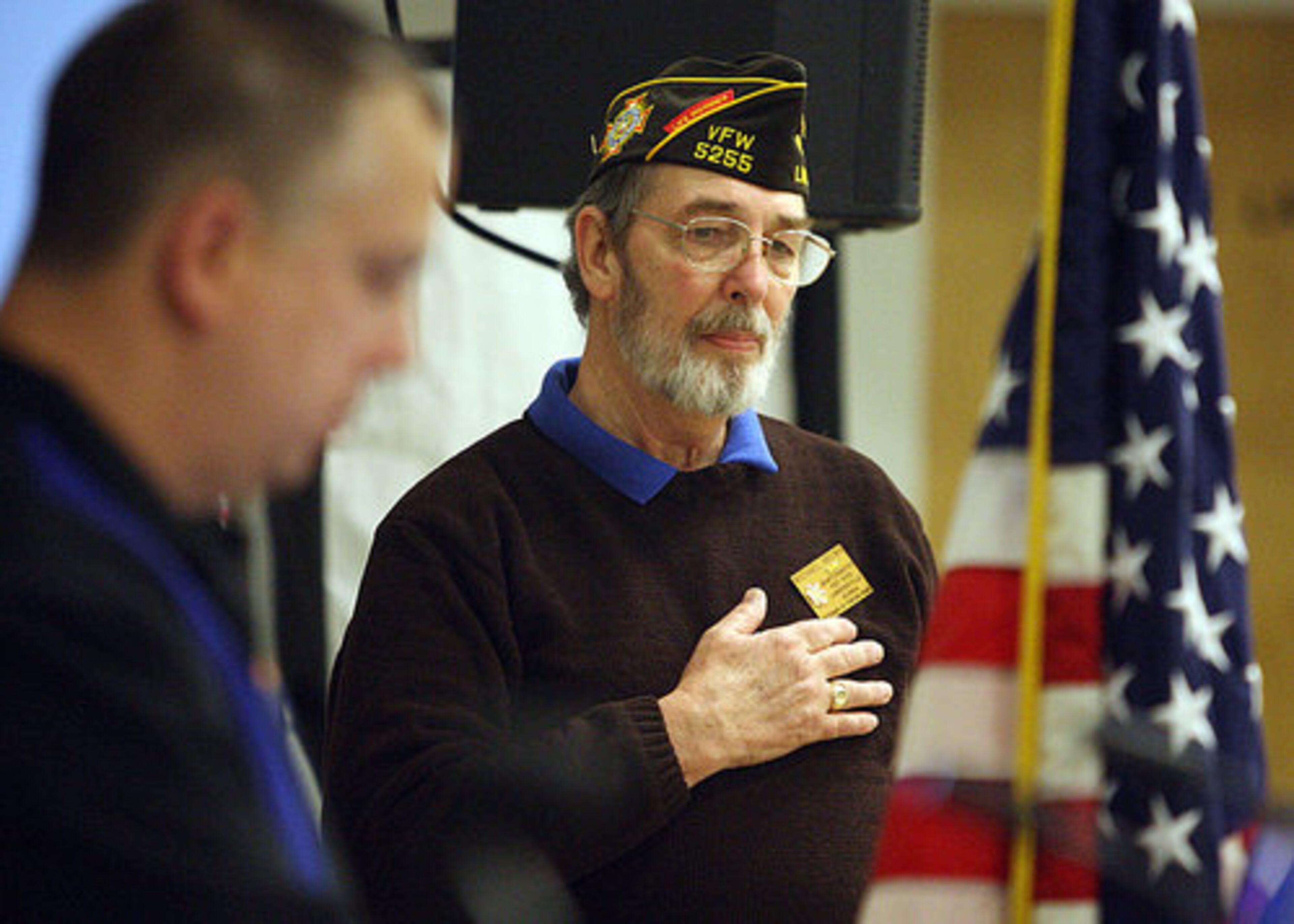 Lawrenceville VFW Post 5255 Quartermaster Mike Brown pledges the flag during the ceremonies in Lawrenceville.