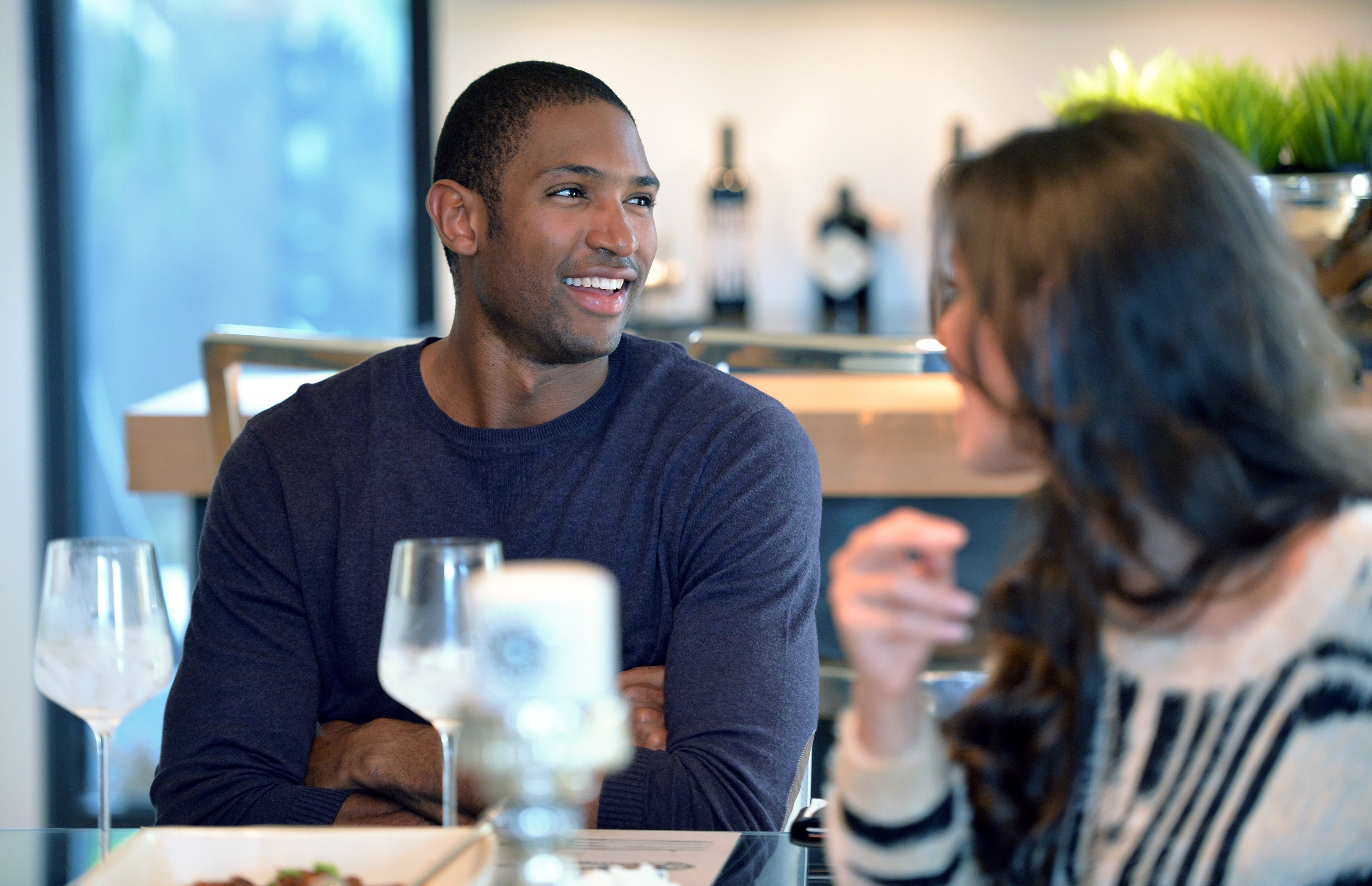 Atlanta Hawks' Al Horford and his wife Amelia Vega talk as they enjoy traditional Dominican food at their home in Atlanta.