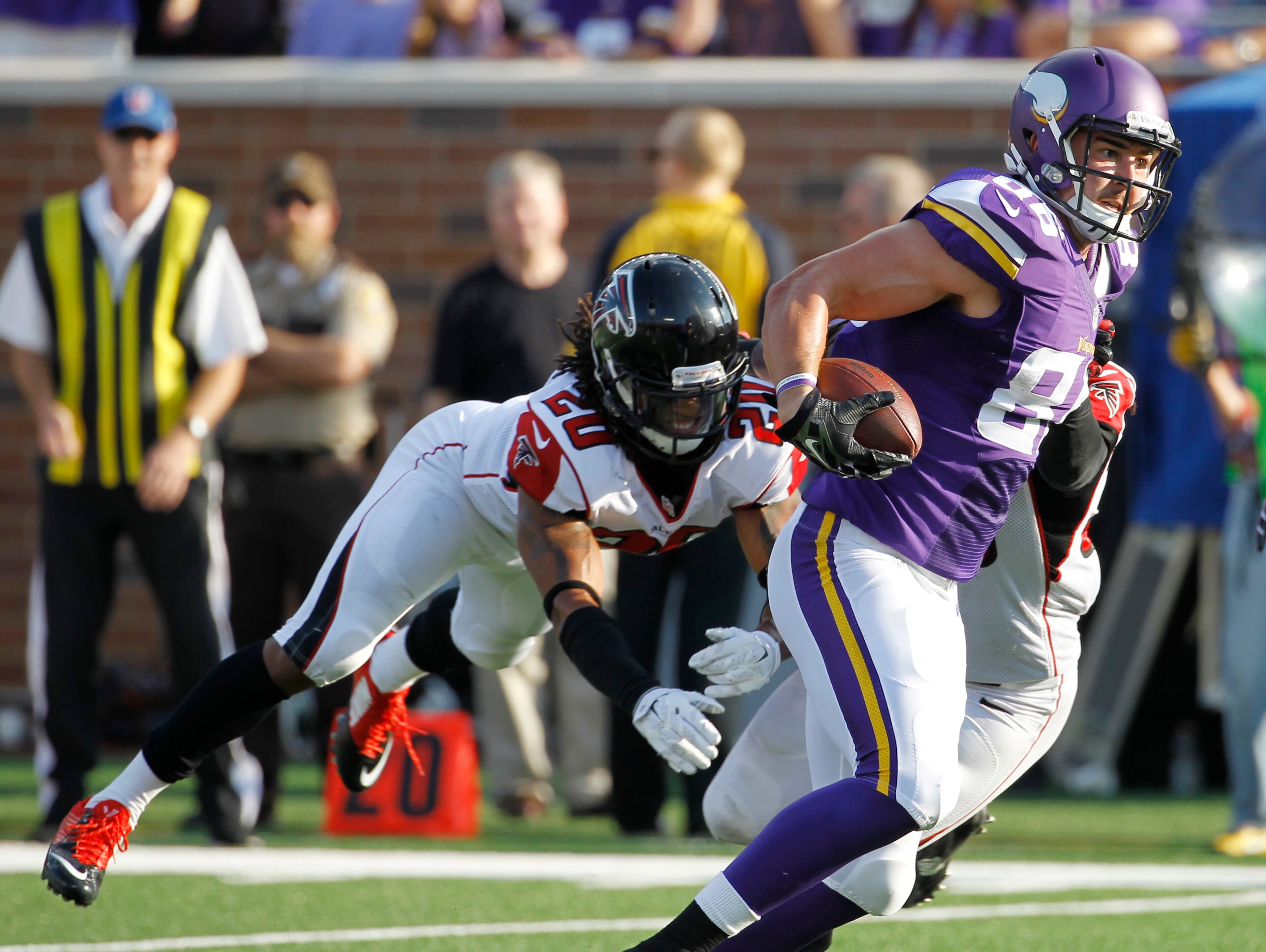 Minnesota Vikings tight end Chase Ford tries to break a tackle by Atlanta Falcons free safety Dwight Lowery (20) after making a reception during the first half of an NFL football game, Sunday, Sept. 28, 2014, in Minneapolis. (AP Photo/Ann Heisenfelt)