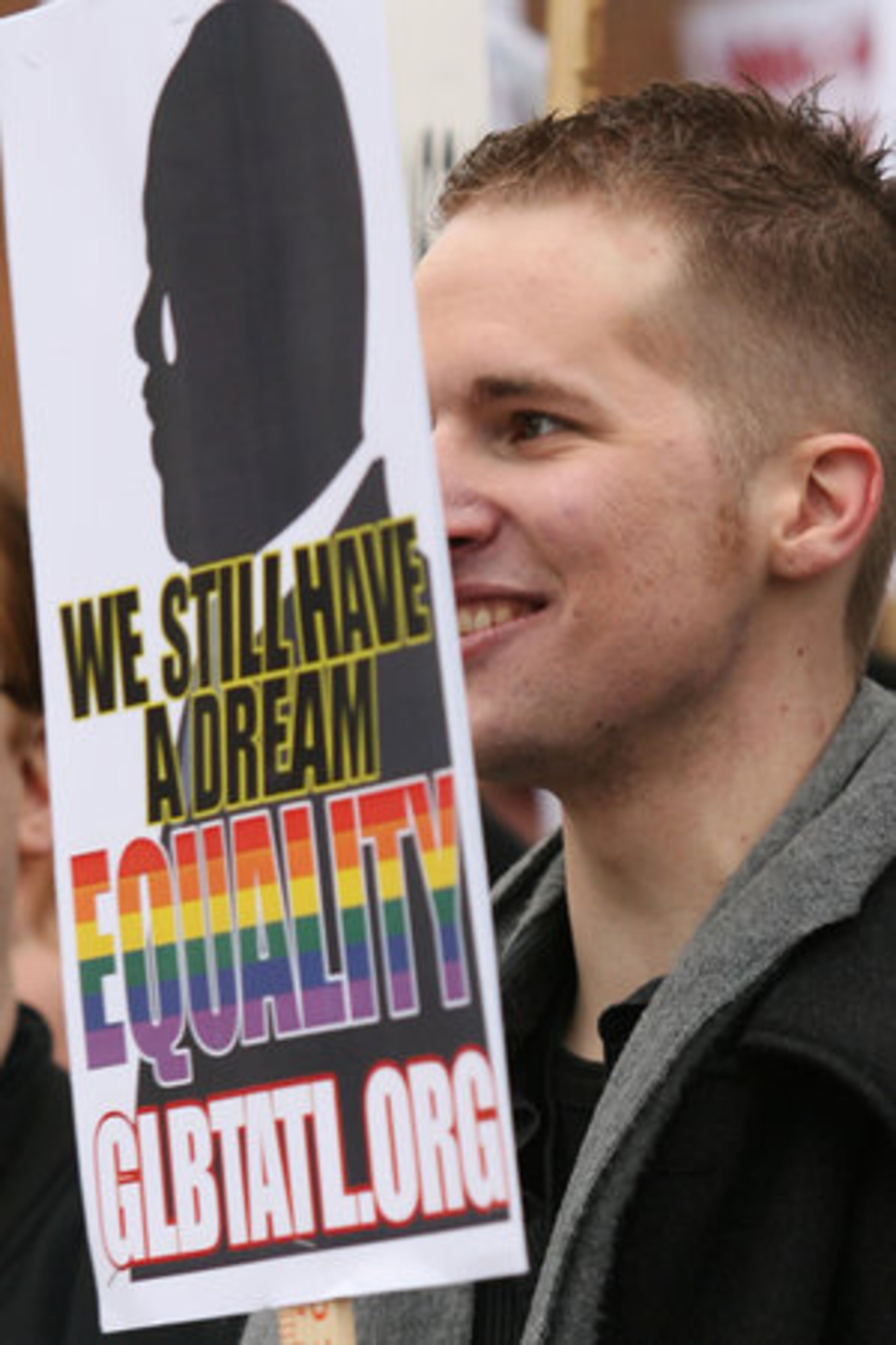Jeff Schade of Atlanta holds a an MLK sign alongside other protesters. "Its the wrong choice on the wrong day," Schade said.