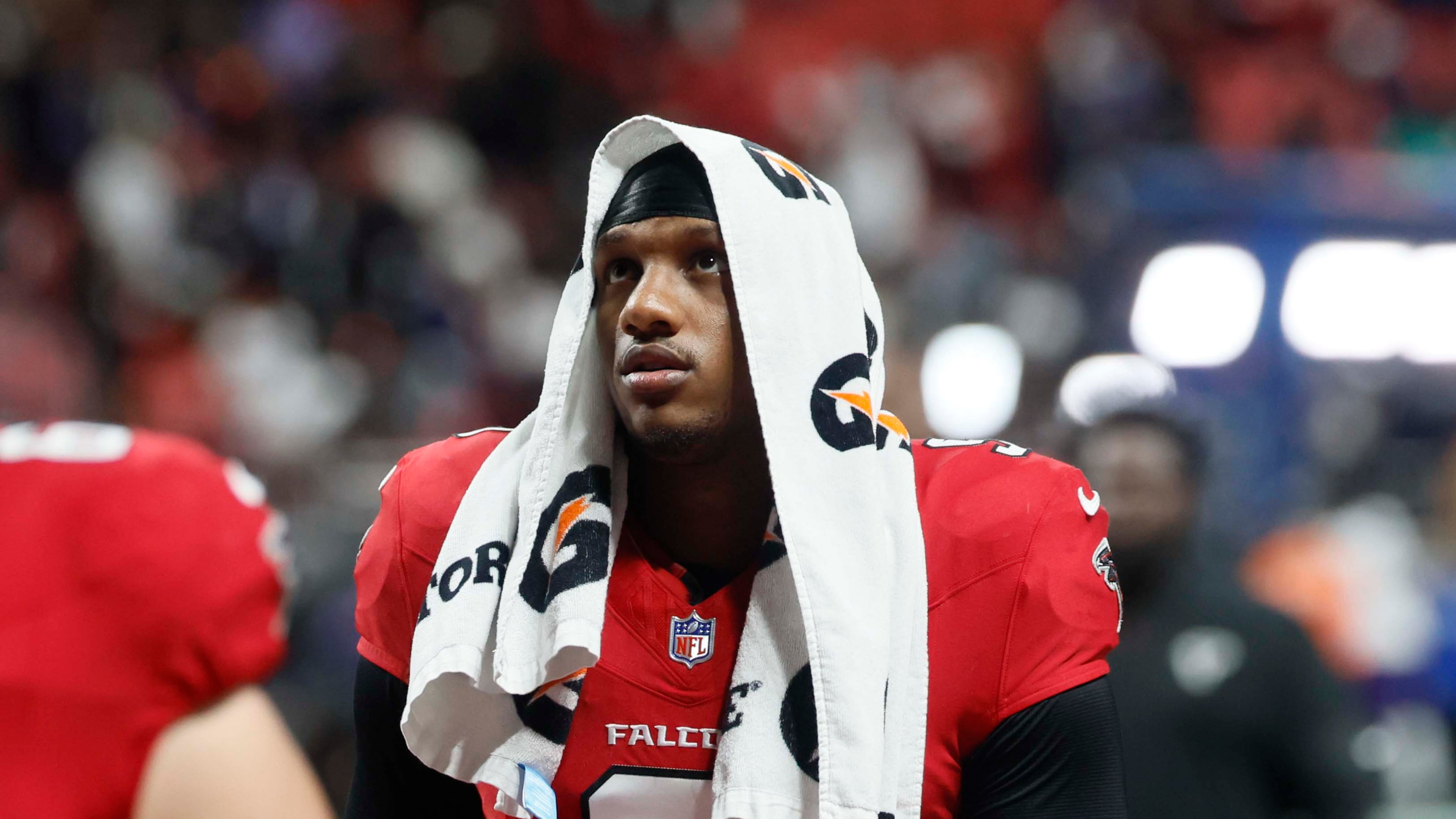 Atlanta quarterback Michael Penix Jr. leaves the field with his head covered after the Falcons lose to the Baltimore Ravens 30-23 in overtime at Mercedes-Benz Stadium on Sunday, Oct. 11, 2026. (Miguel Martinez/AJC)
