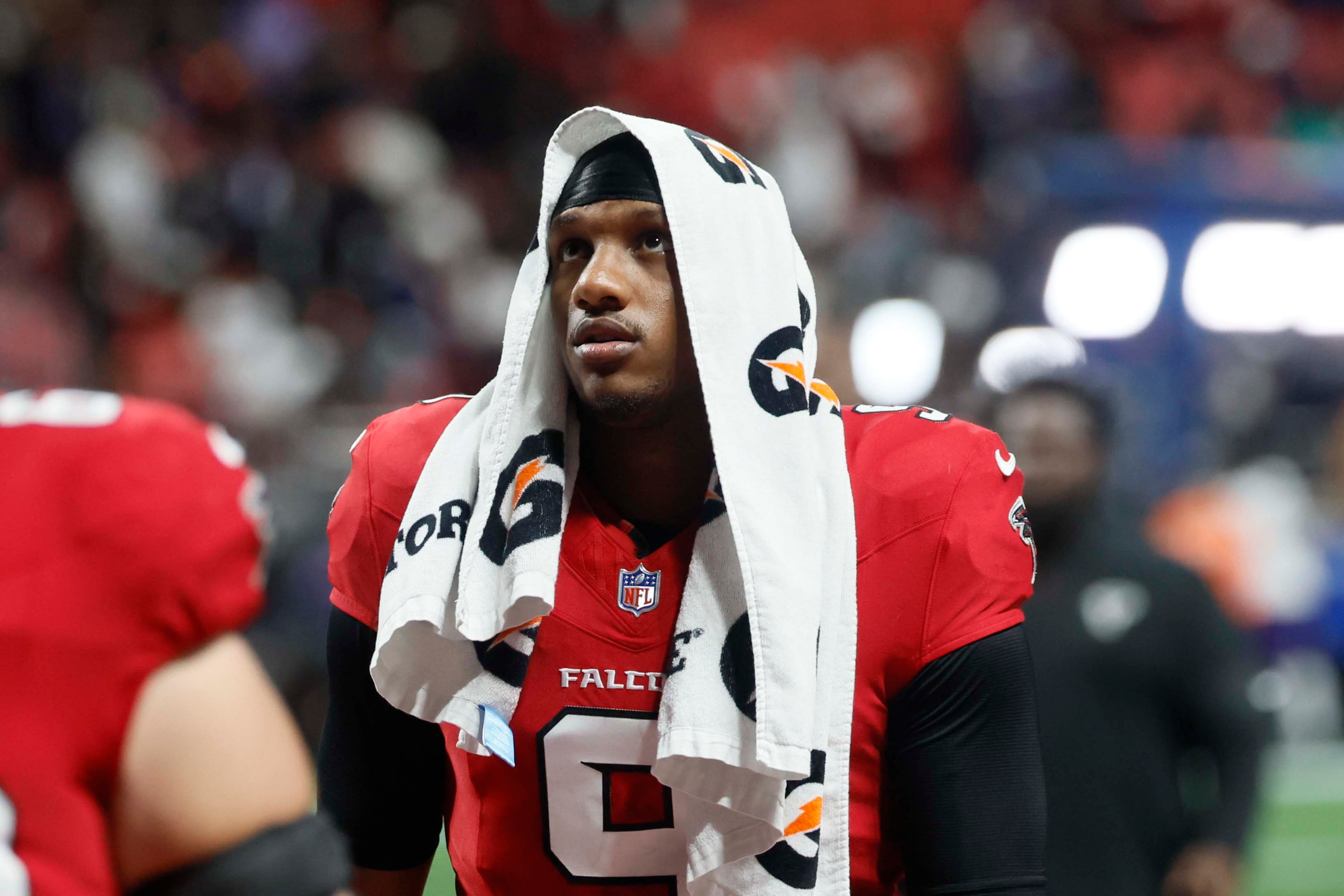 Atlanta Falcons quarterback Michael Penix Jr. (9) leaves the field, covering his head, after the Falcons lose to the Baltimore Ravens 30-23 in overtime at Mercedes-Benz Stadium in Atlanta, GA, on Sunday, Oct. 11, 2026. (Miguel Martinez/AJC)
