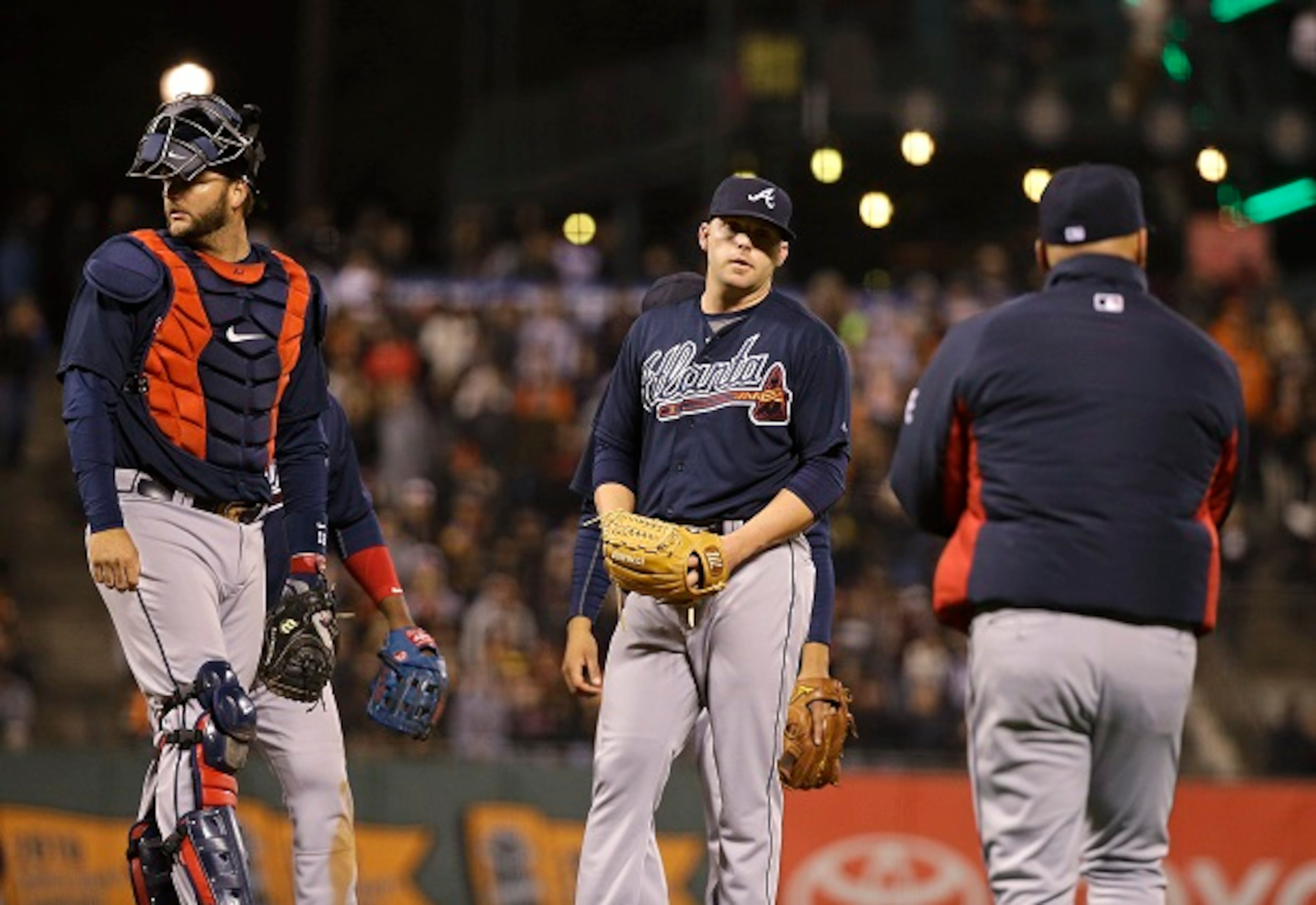 Atlanta Braves relief pitcher Brandon Cunniff, center, stands on the mound as manager Fredi Gonzalez, right, comes out to remove him during the eighth inning of the Braves' baseball game against the San Francisco Giants on Thursday, May 28, 2015, in San Francisco. At left is catcher A.J. Pierzynski. (AP Photo/Eric Risberg)