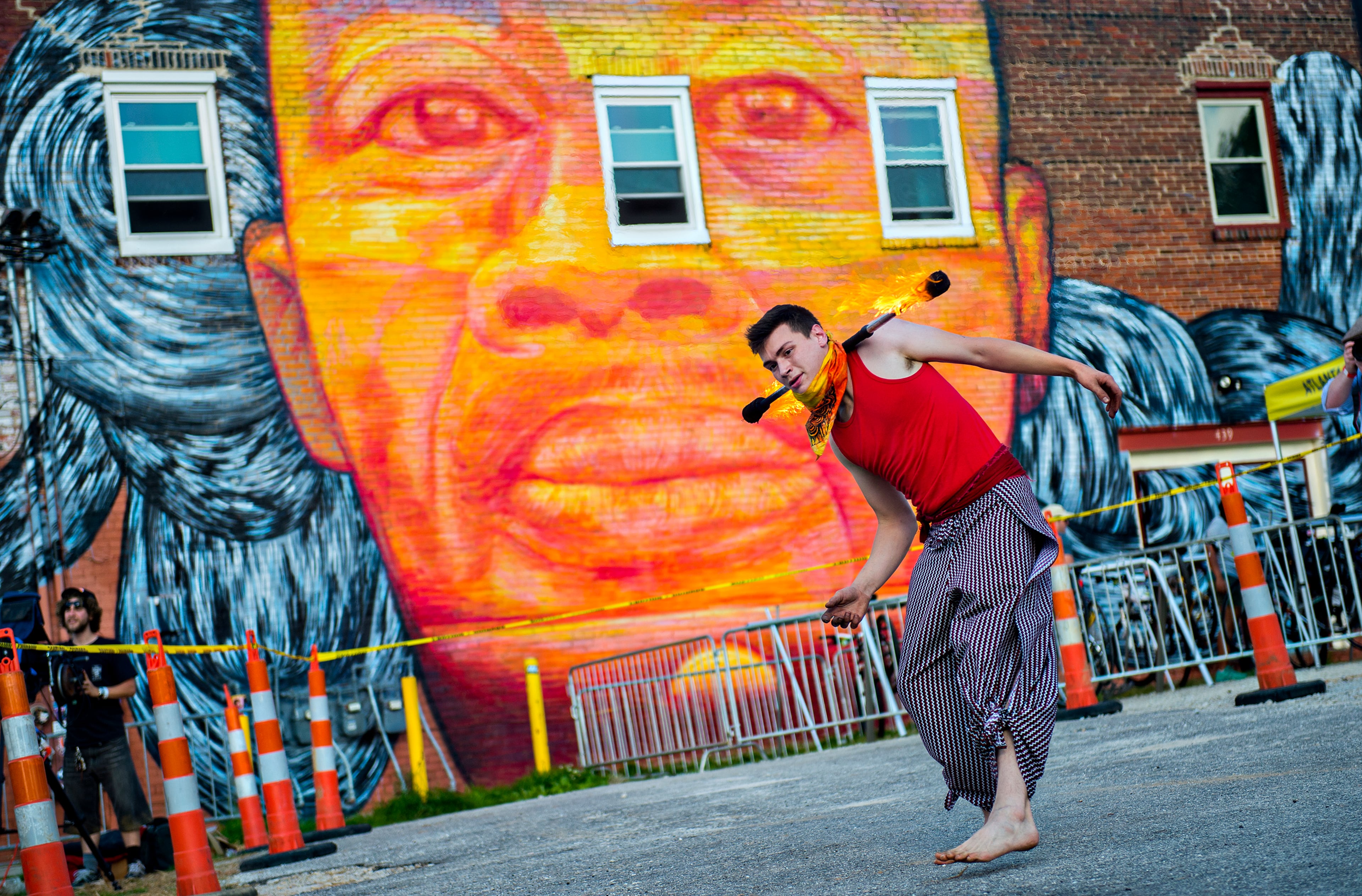 Zac Ogilvie, known as Binx, spins fire during the Fire in the Fourth Festival in the Old Fourth Ward neighborhood of Atlanta on Saturday, May 2, 2015. The first annual festival featured a live musical and fire performances, firefighter muster relays, and aerial acrobatics by the Imperial Opa Circus. JONATHAN PHILLIPS / SPECIAL