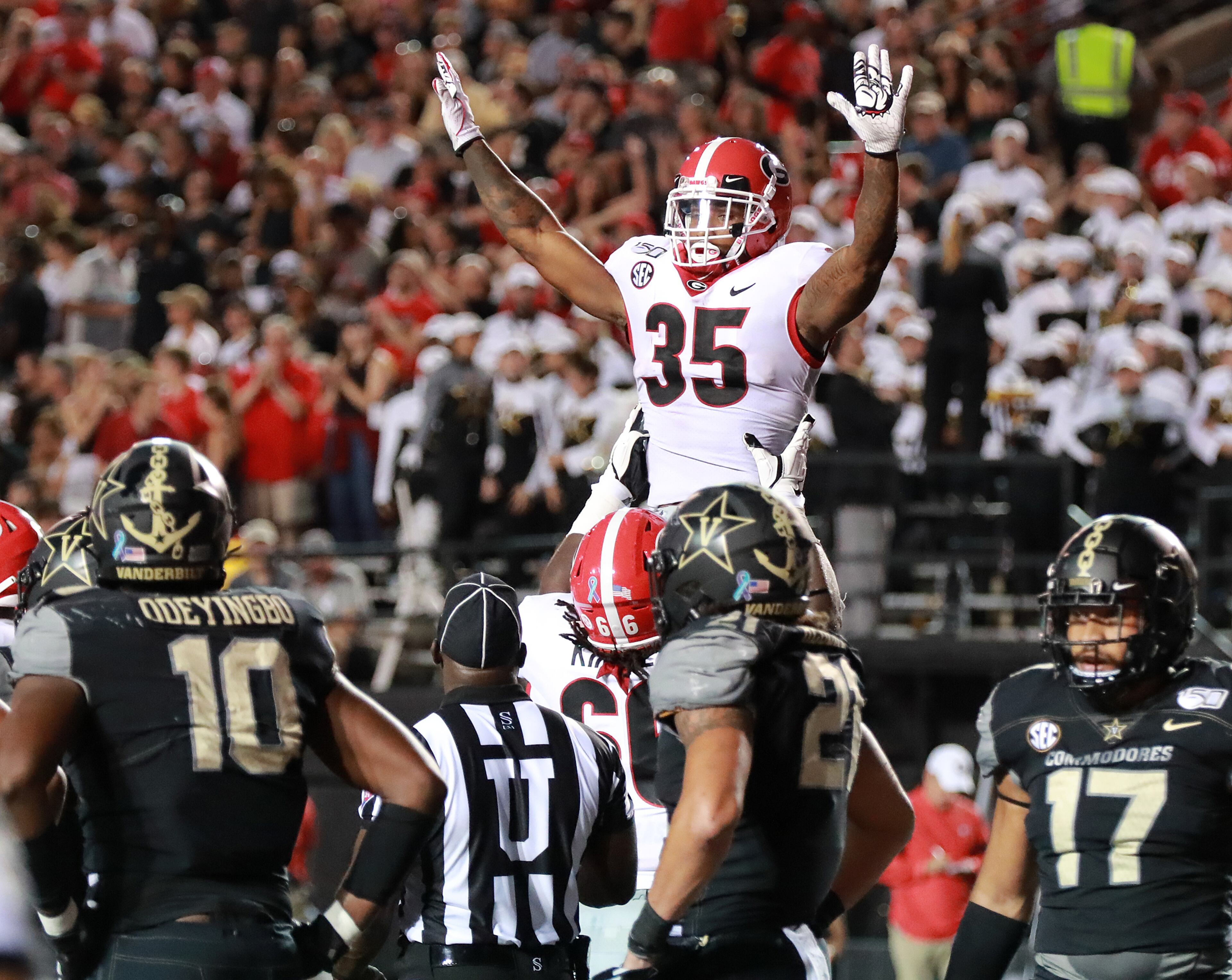 Georgia tailback Brian Herrien gets a hoist from Solomon Kindley celebrating his touchdown to take a 21-0 lead over Vanderbilt during the second quarter in a NCAA college football game on Saturday, August 31, 2019, in Nashville. Curtis Compton/ccompton@ajc.com