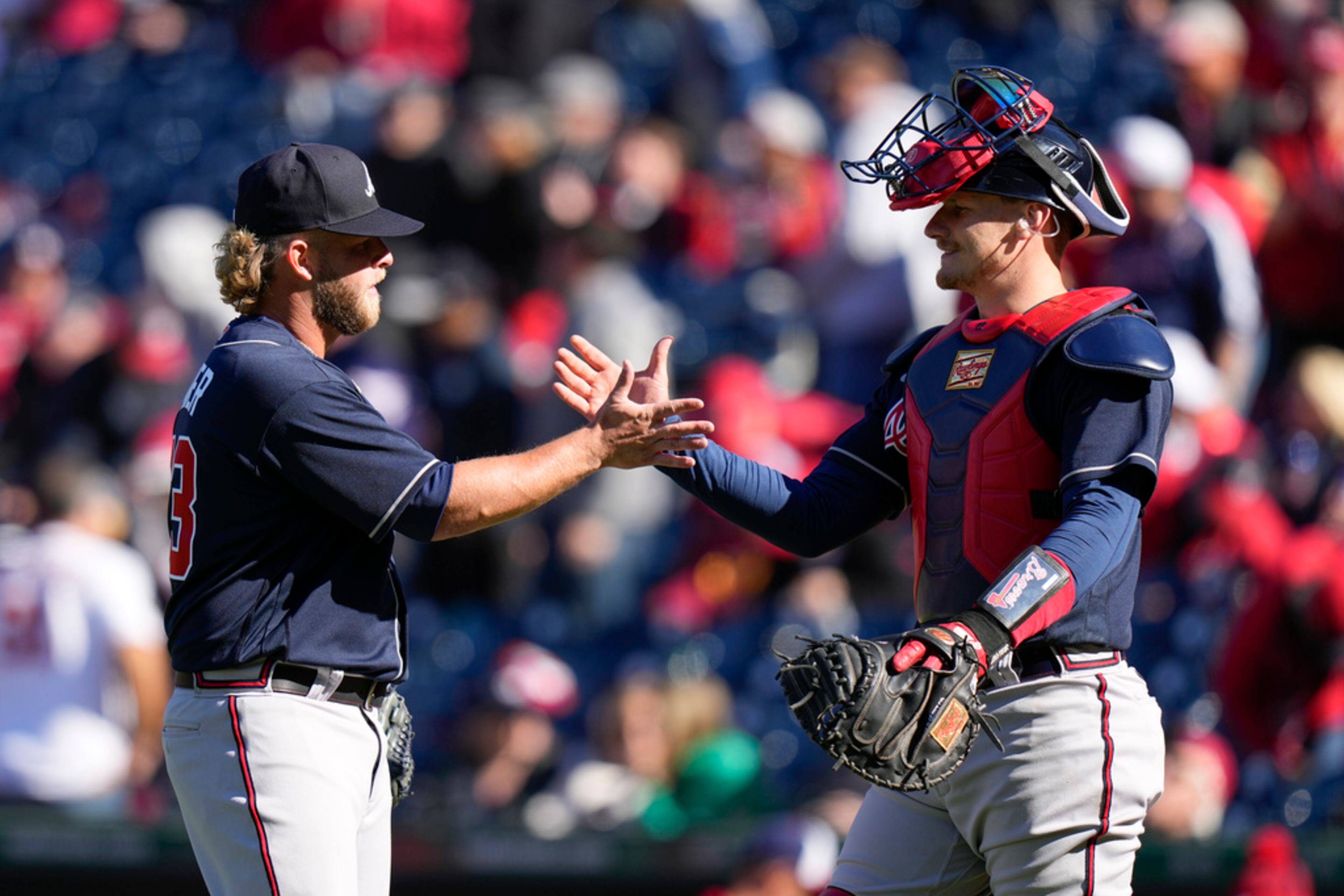 Atlanta Braves relief pitcher A.J. Minter, left, and catcher Sean Murphy high-five after closing out an opening day baseball game against the Washington Nationals at Nationals Park, Thursday, March 30, 2023, in Washington. Atlanta won 7-2. (AP Photo/Alex Brandon)