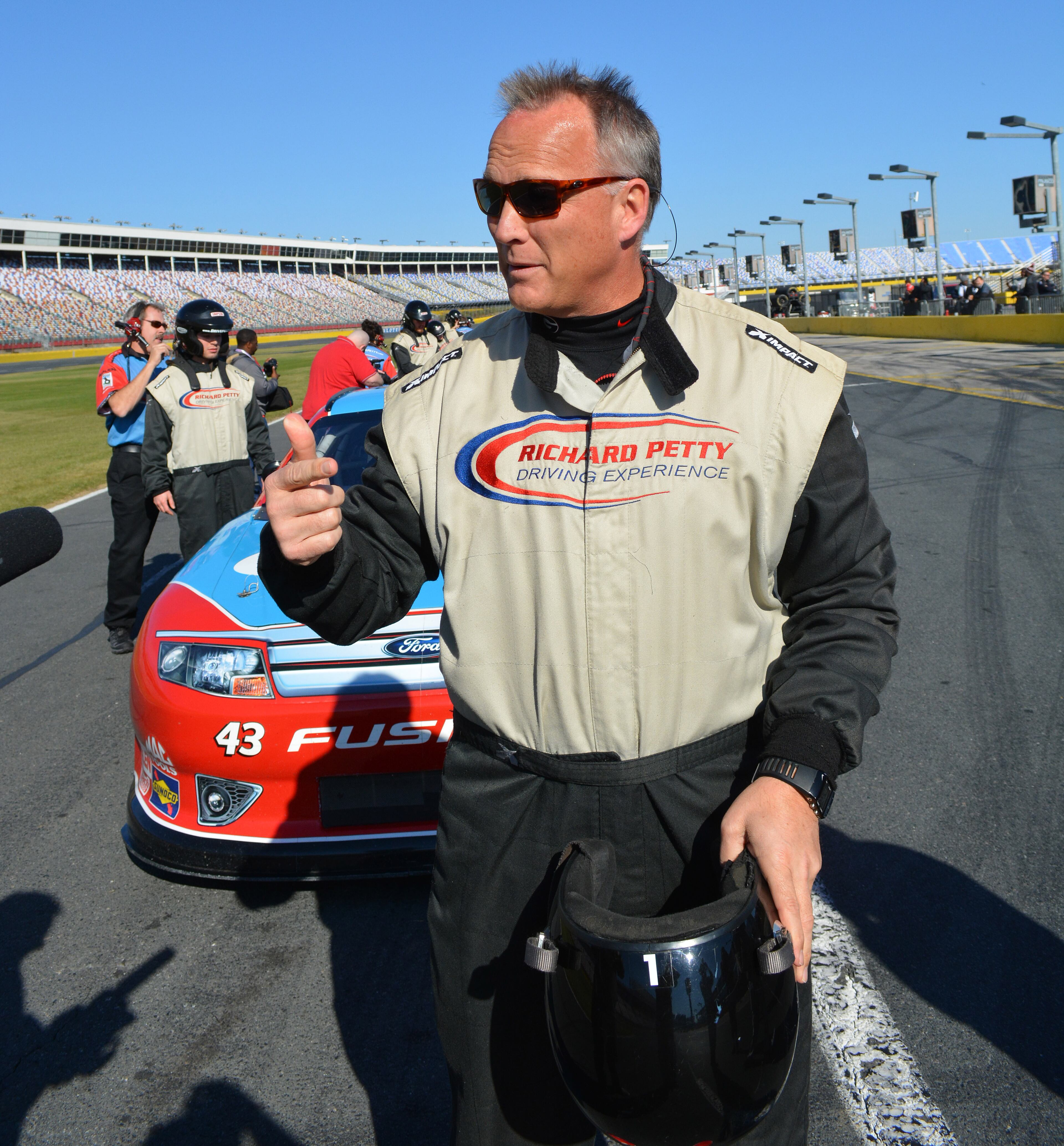 Coach Mark Richt talks after his ride as the Bulldogs participated in the Richard Petty Driving Experience at Charlotte Motor Speedway on Saturday, Dec. 27, 2014. (Photo by Steven Colquitt / UGA Sports)
